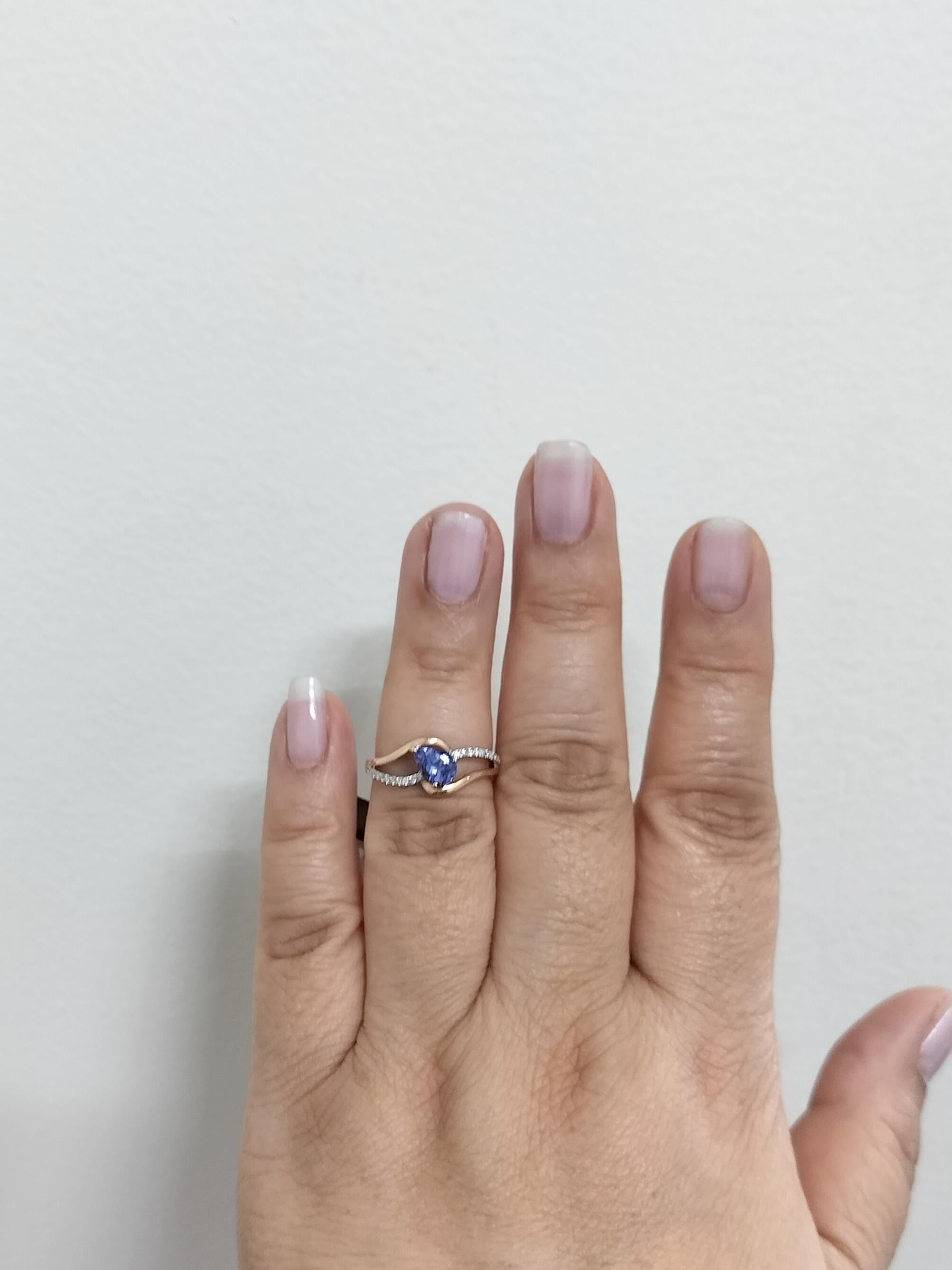 Beautiful 0.60 ct. tanzanite pear shape with 0.12 ct. white diamond rounds.  Handmade in 14k rose gold and white gold.  Ring size 6.5.