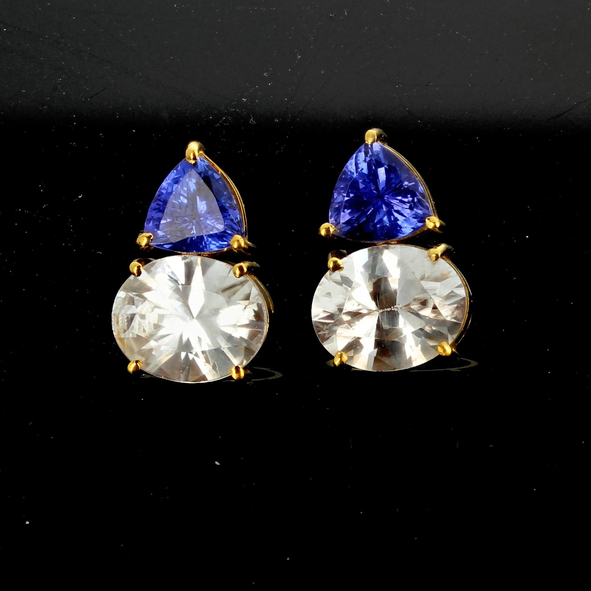 Brilliantly glittering natural white Cambodian Zircons are elegantly enhanced by gorgeous bright blue Tanzanites set in 18KT yellow gold stud earrings.  The Zircons are approximately 5.1 carats each and the Tanzanites approximately 3.18 carats each.