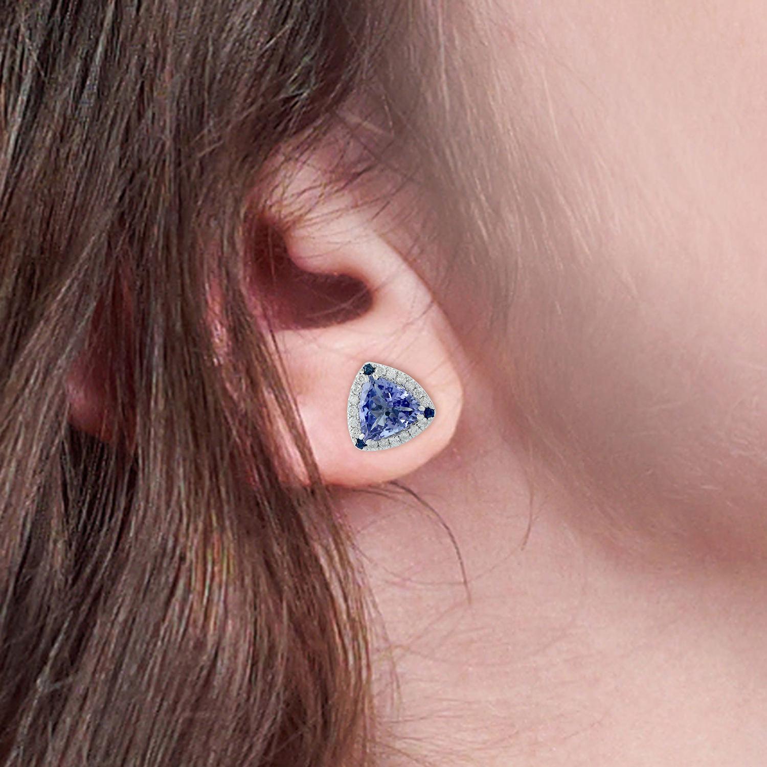 Cast from 18-karat gold, these beautiful stud earrings are hand set with 2.1 carats tanzanite, .05 carats blue sapphire and .24 carats of sparkling diamonds. 

FOLLOW  MEGHNA JEWELS storefront to view the latest collection & exclusive pieces. 