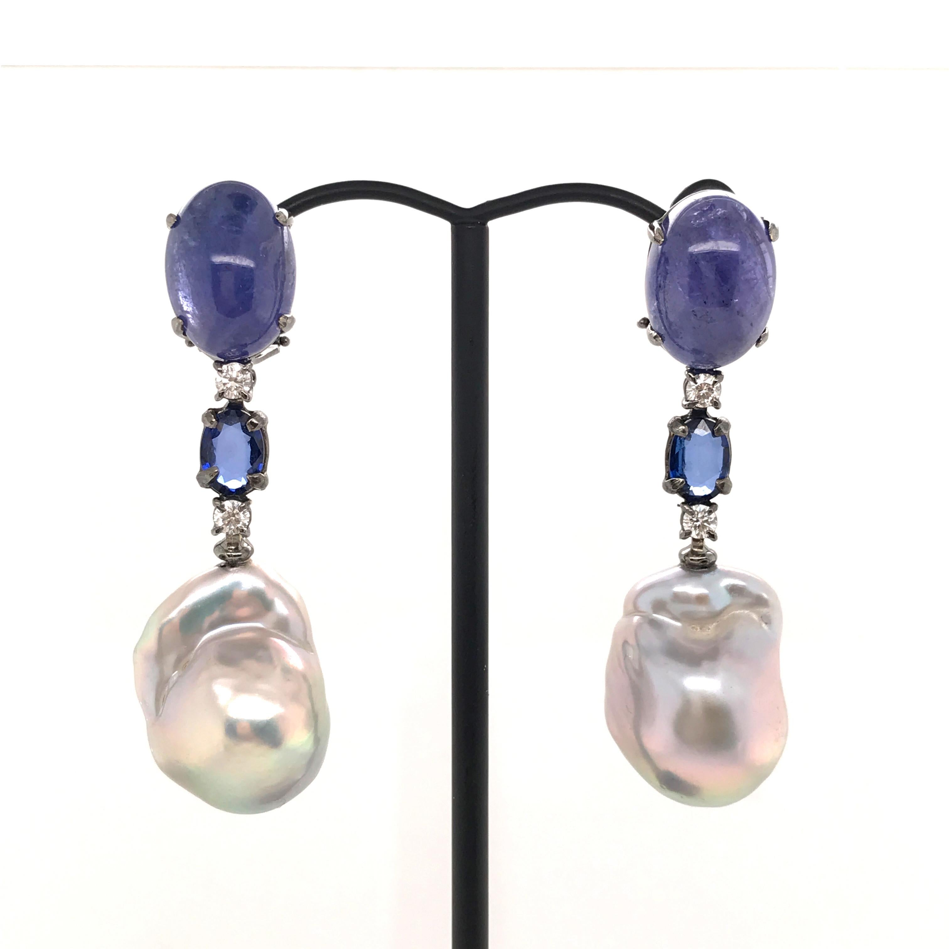 Natural Tanzanite Blue Sapphire and diamonds on Black Gold 18 k Chandelier Earrings 
2 Tanzanite, 
2 Blue Sapphire 
2 diamonds 0.28 ct Color G purity VS
Black Gold 18 k weight 5 grams
Chandelier Earrings
Can be adapted to ear not pierced