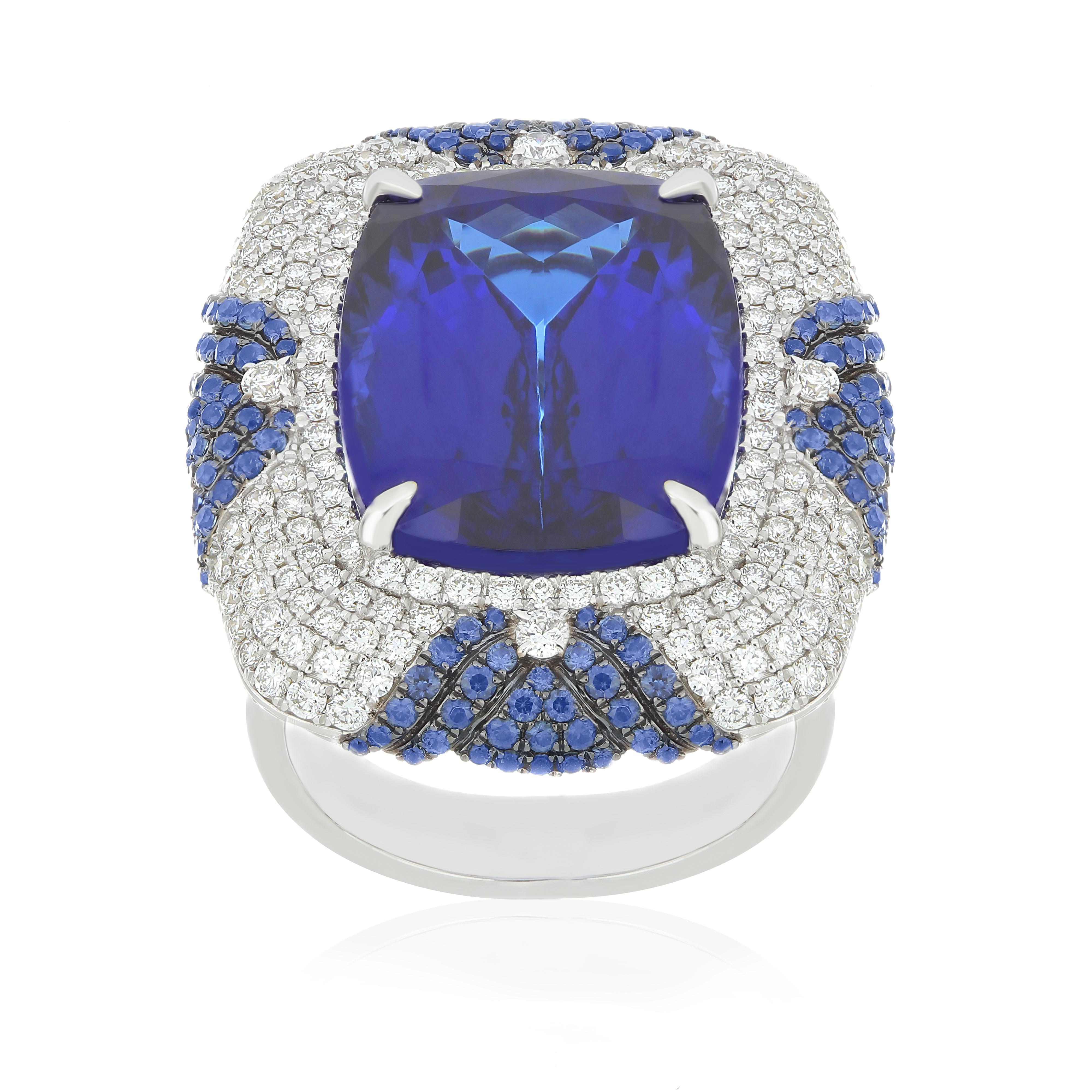 Elegant and Exquisitely detailed White Gold Ring, with a rare 24.30Cts (approx.) Cushion Round Corner
Tanzanite set in the center beautifully accented with Micro pave set Diamonds, weighing approx. 2.50 CT's (approx.). total carat weight and Blue