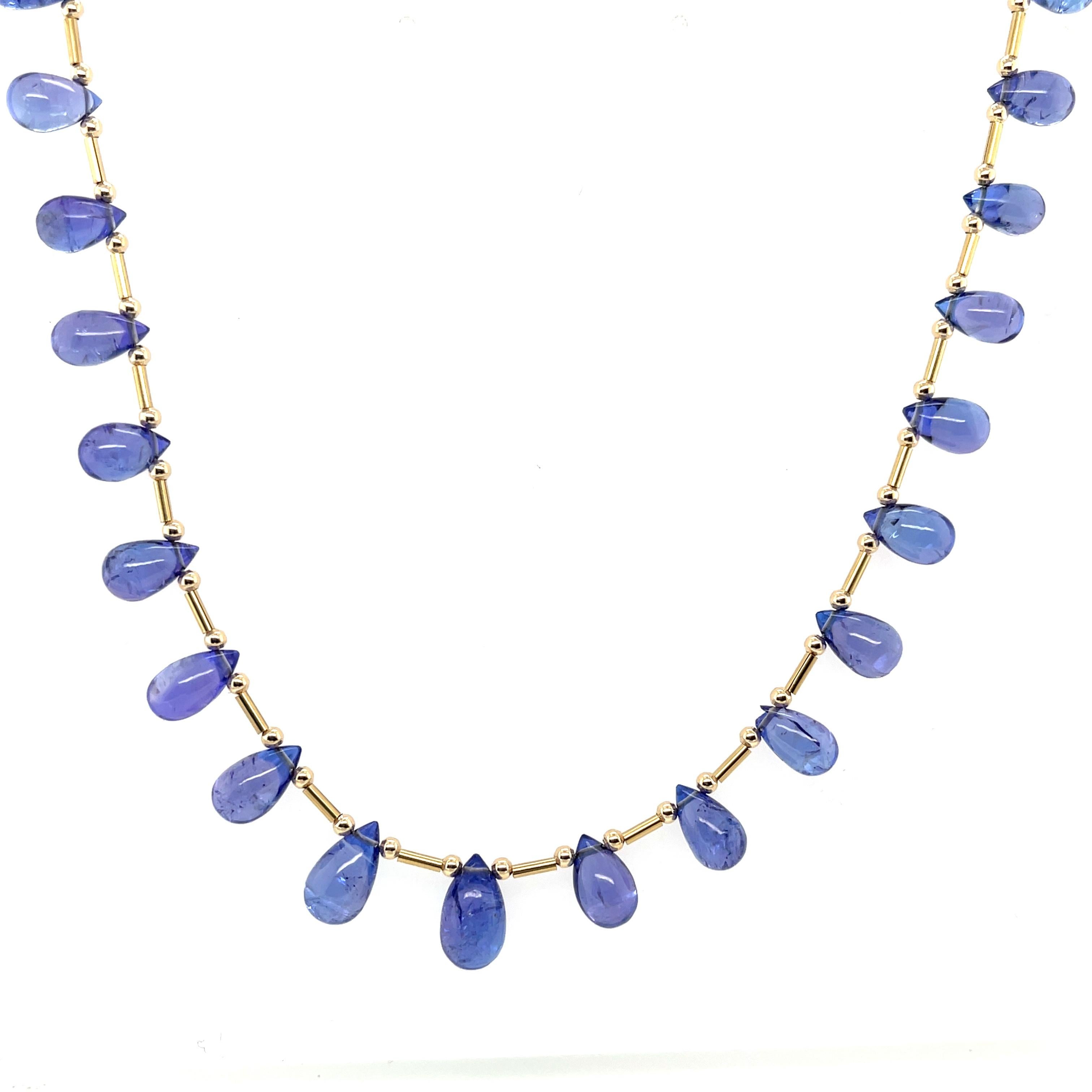 This striking tanzanite necklace features a collection of briolette cut beads with gorgeous medium bluish purple color and lovely transparency that catches the light beautifully. Graduating in size from 1/4