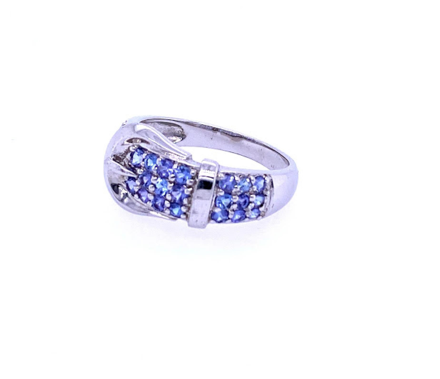 Sterling Silver (stamped 925 CHINA) buckle design ring featuring 29 2mm round tanzanite stones. Measuring 10.9mm at the widest and tapers to 2.85mm at the base. The ring is a finger size 9.