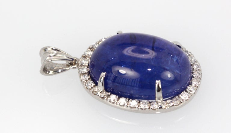 Tanzanite Cabochon Pendant Diamonds 18K is brand new and never been worn.  This tanzanite is a gorgeous shade of blue with nice metrics and it is large 21 Carats with a Diamond Border of .50 Carats of Diamonds.
This pendant is high domed just like