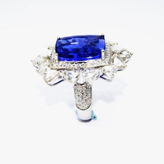 Tanzanite Cocktial Ring in 18 Karat Gold Nested in an Oval Crown of Diamonds