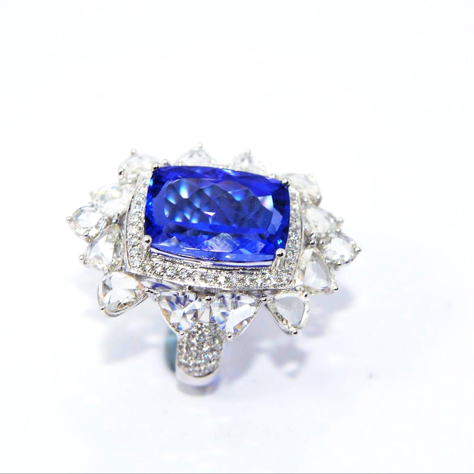 Emerald Cut Tanzanite Cocktial Ring in 18 Karat Gold Nested in an Oval Crown of Diamonds