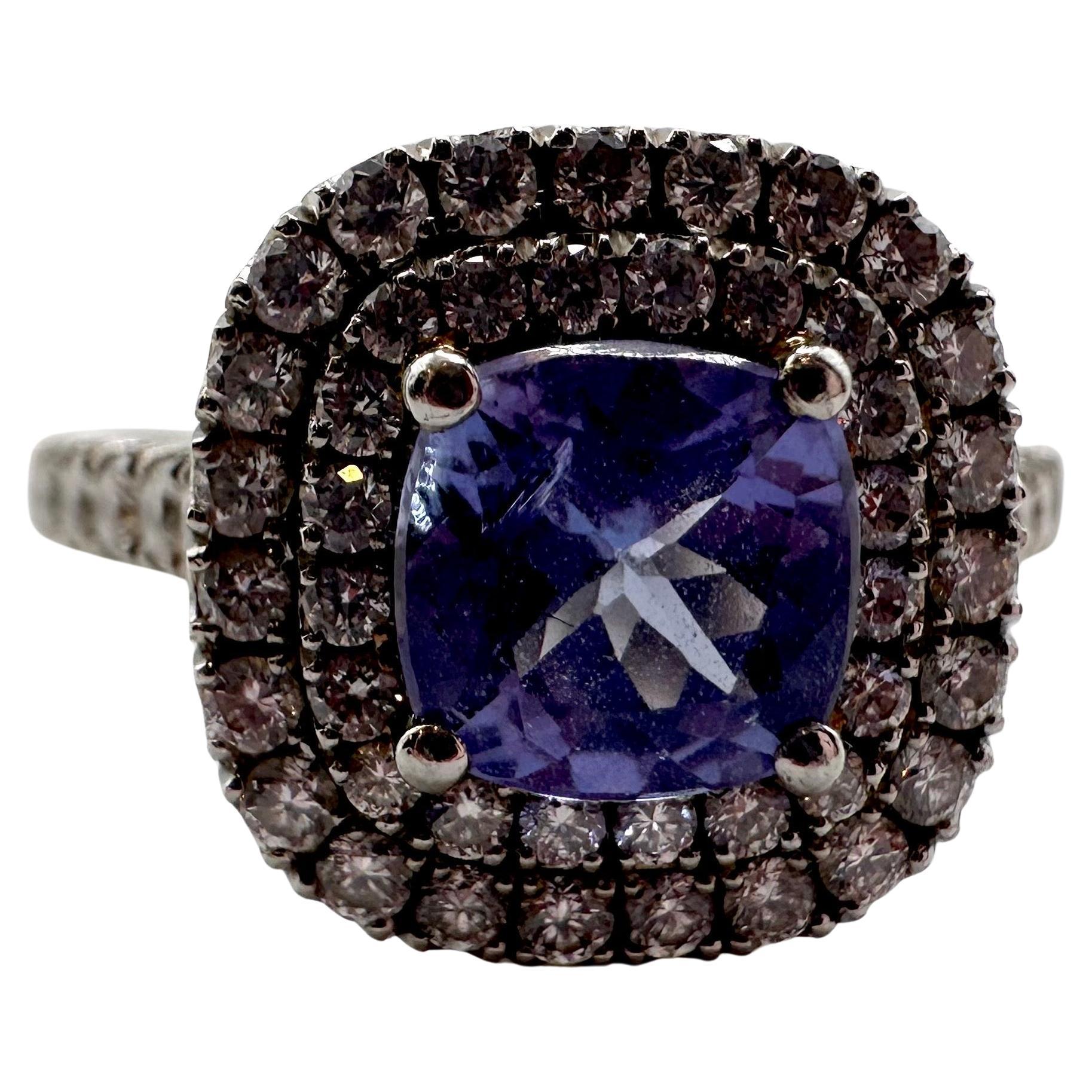 Stunning engagement ring with a 1ct tanzanite surrounded by natural diamonds double halo style in 14KT white gold. The ring is size 6 and can be re-sized.
The diamonds are totaling 1.40 carats VS-SI clarity and F color, the tanzanite is a stunning