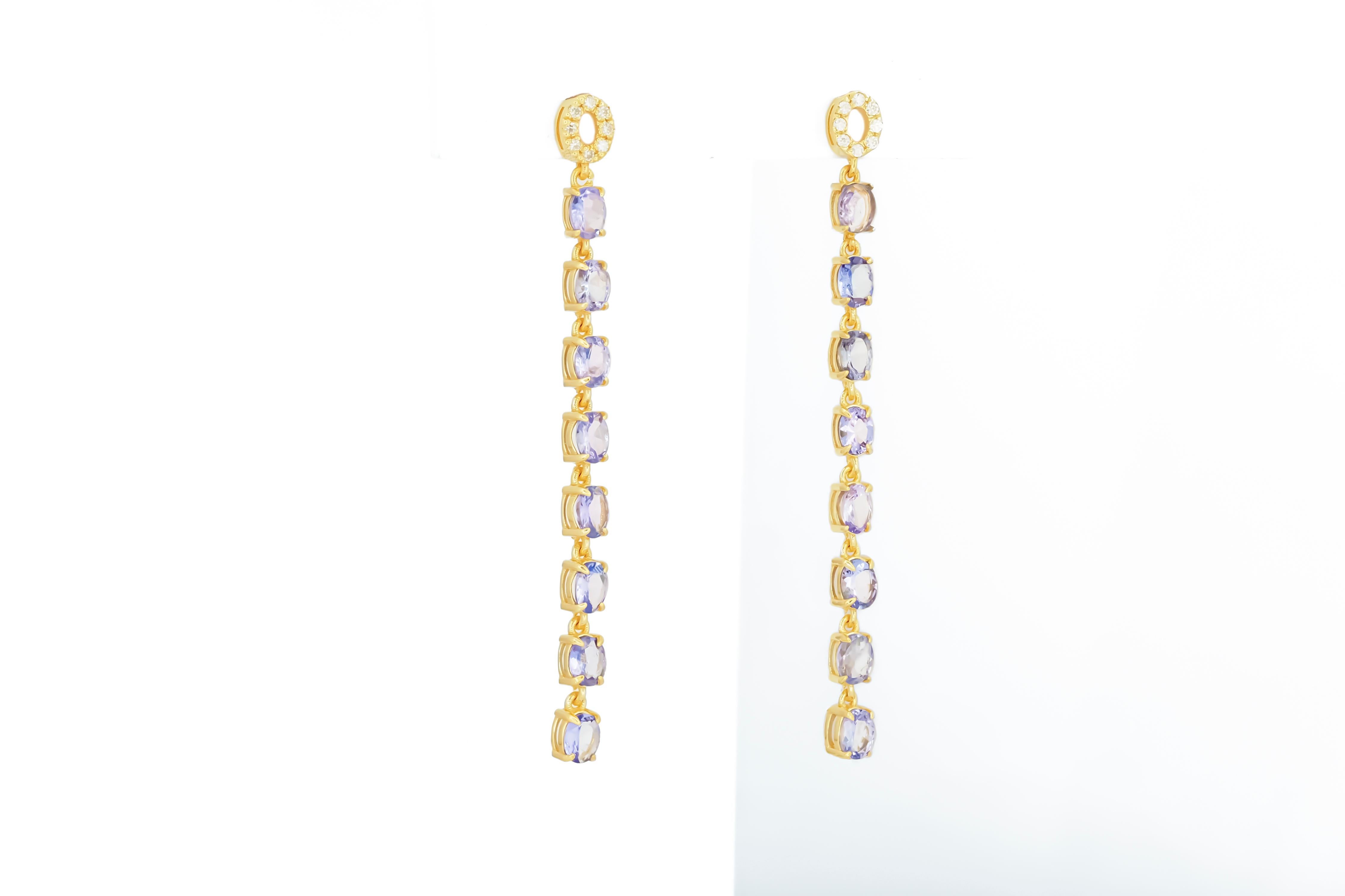 Modern Tanzanite dangle earrings studs in 14k gold.  For Sale