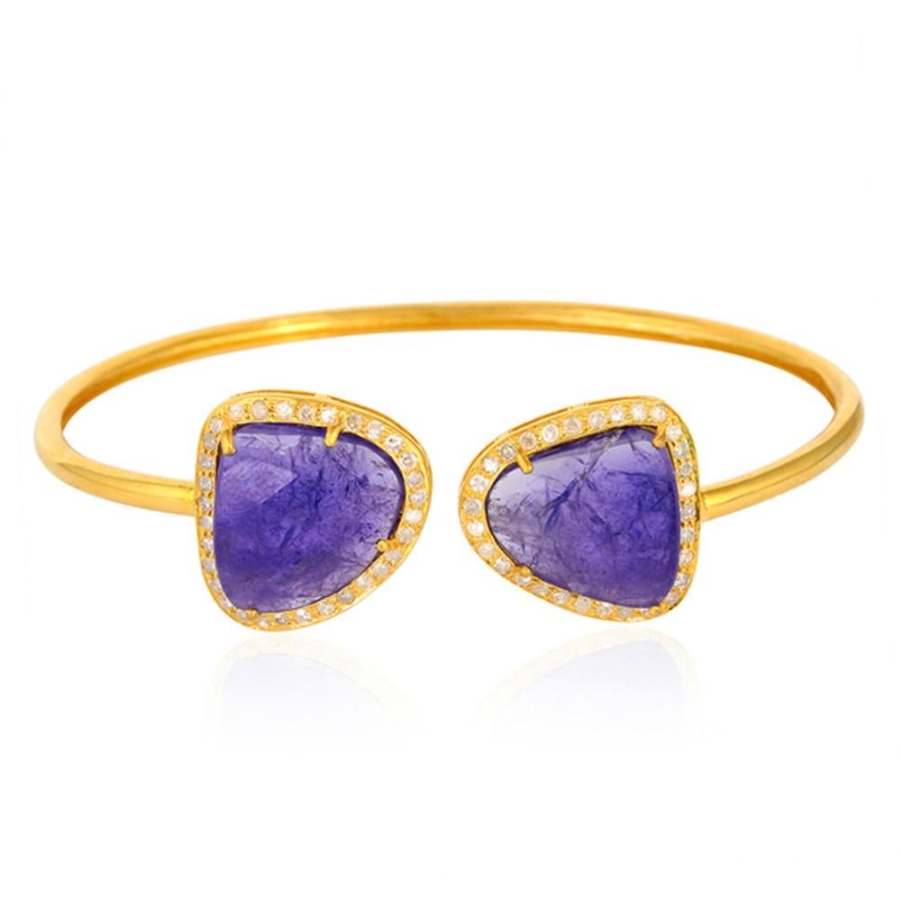 A beautiful bangle bracelet handmade in 18K yellow gold. It is set in 14.48 carats tanzanite and .68 carats of sparkling diamonds. 

FOLLOW  MEGHNA JEWELS storefront to view the latest collection & exclusive pieces.  Meghna Jewels is proudly rated