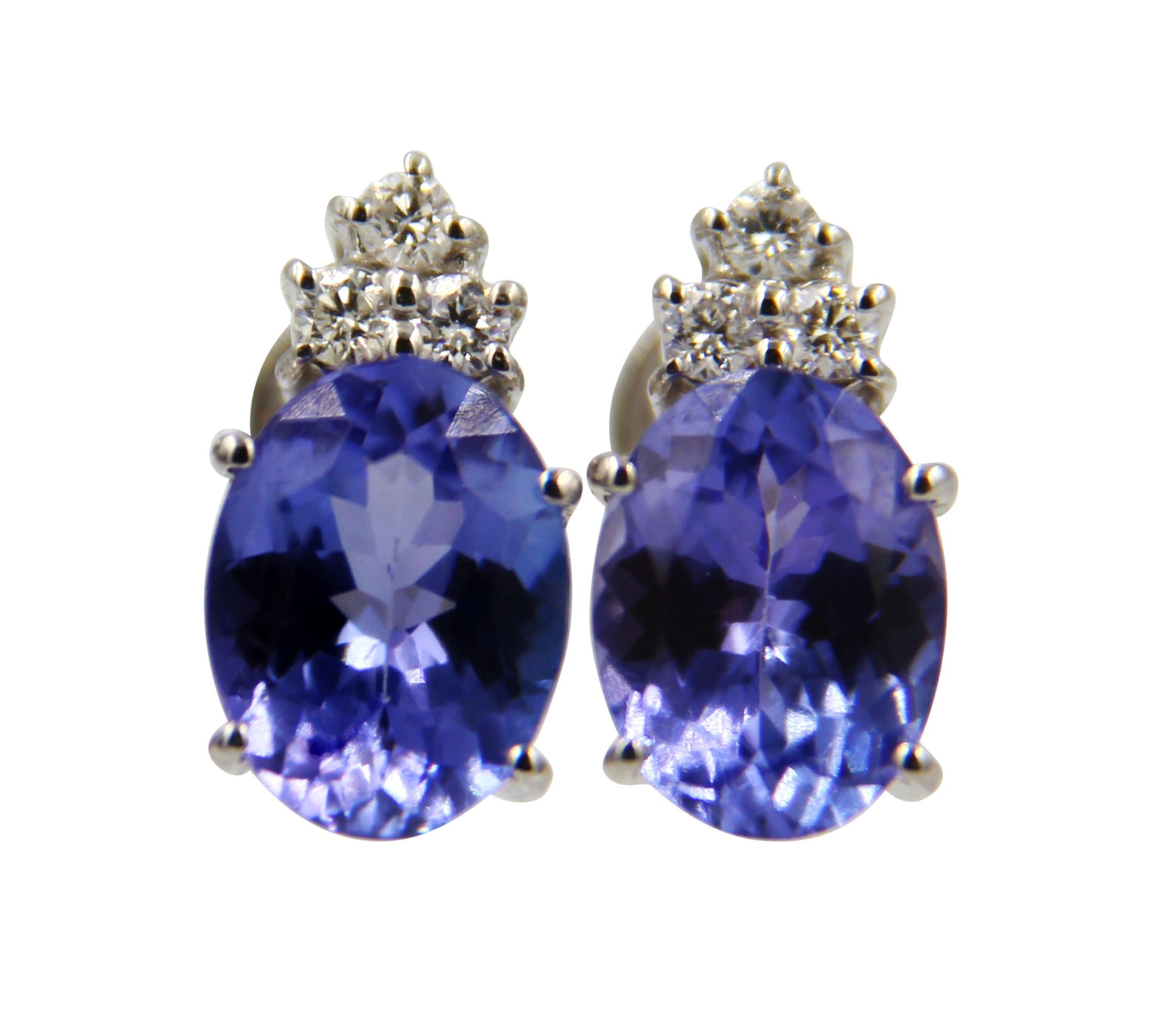 A beautiful pair of Earrings featuring 2.25 Carat Oval Shaped Tanzanite and 0.12 Carat Diamonds set in 18 Karat White Gold.
