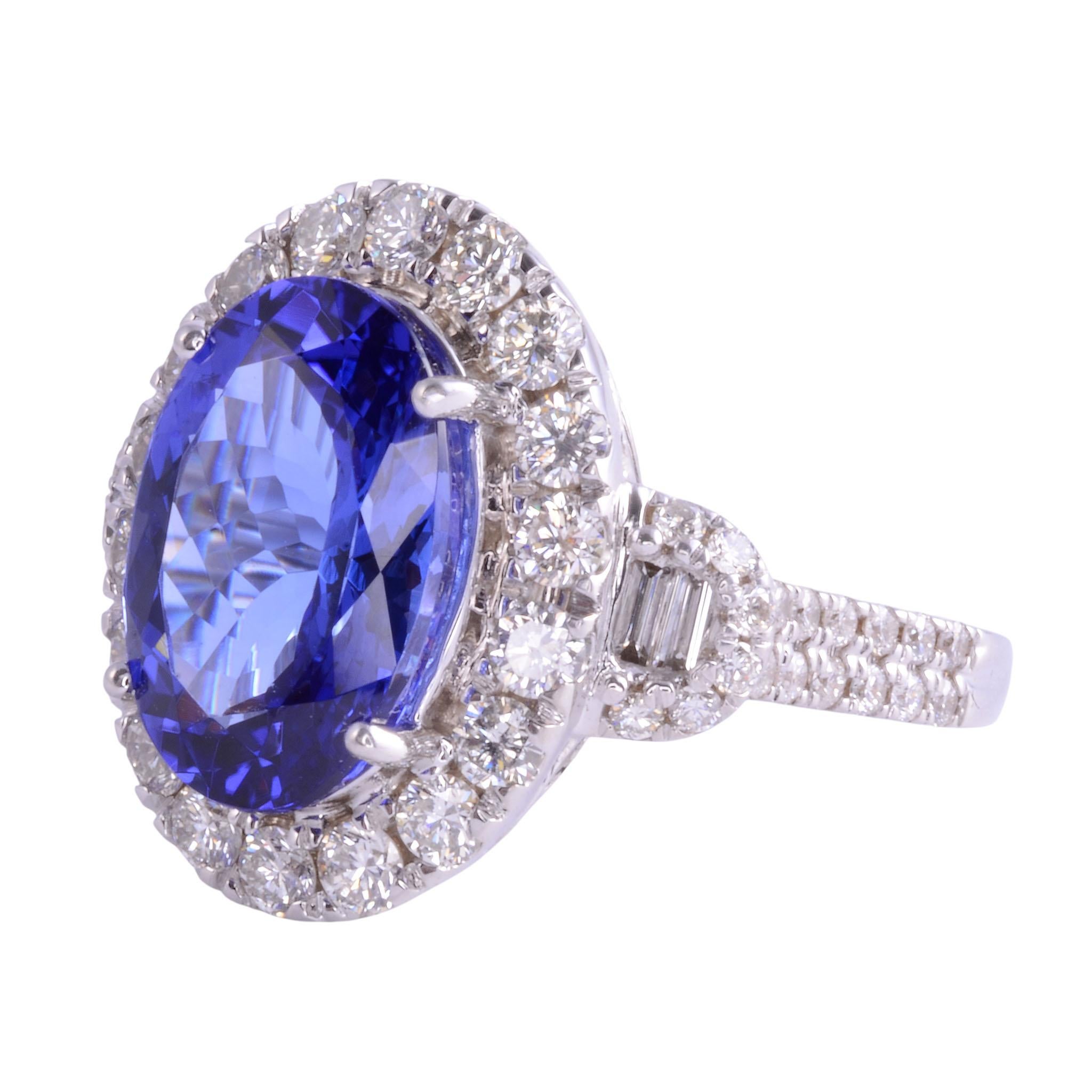 Estate tanzanite & diamond 18K white gold ring. This 18 karat white gold ring features an oval 5.08 carat tanzanite center accented with 1.39 carat total weight of diamonds. There are 54 full cut diamonds at 1.19 carat total weight having VS2-SI2