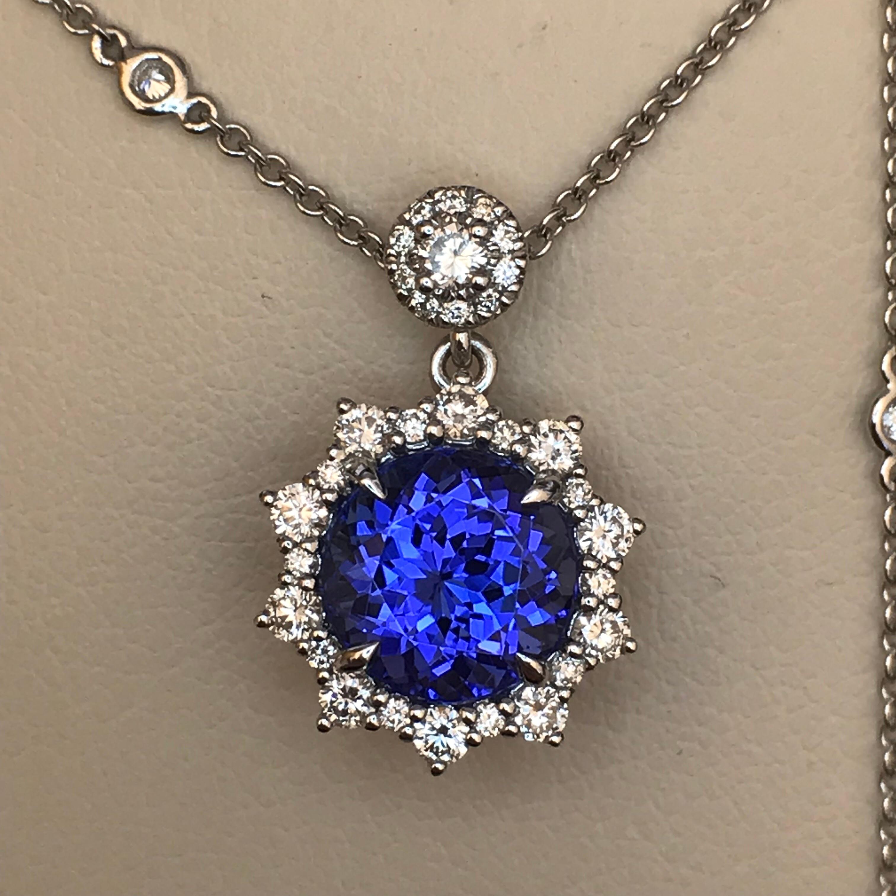 Inspired by stars against the celestial blue of night, this pendant features a vivid blue-violet tanzanite framed by a star-like halo of diamonds. It is suspended from a diamond within a halo, and additional spectacle-set diamonds are placed along