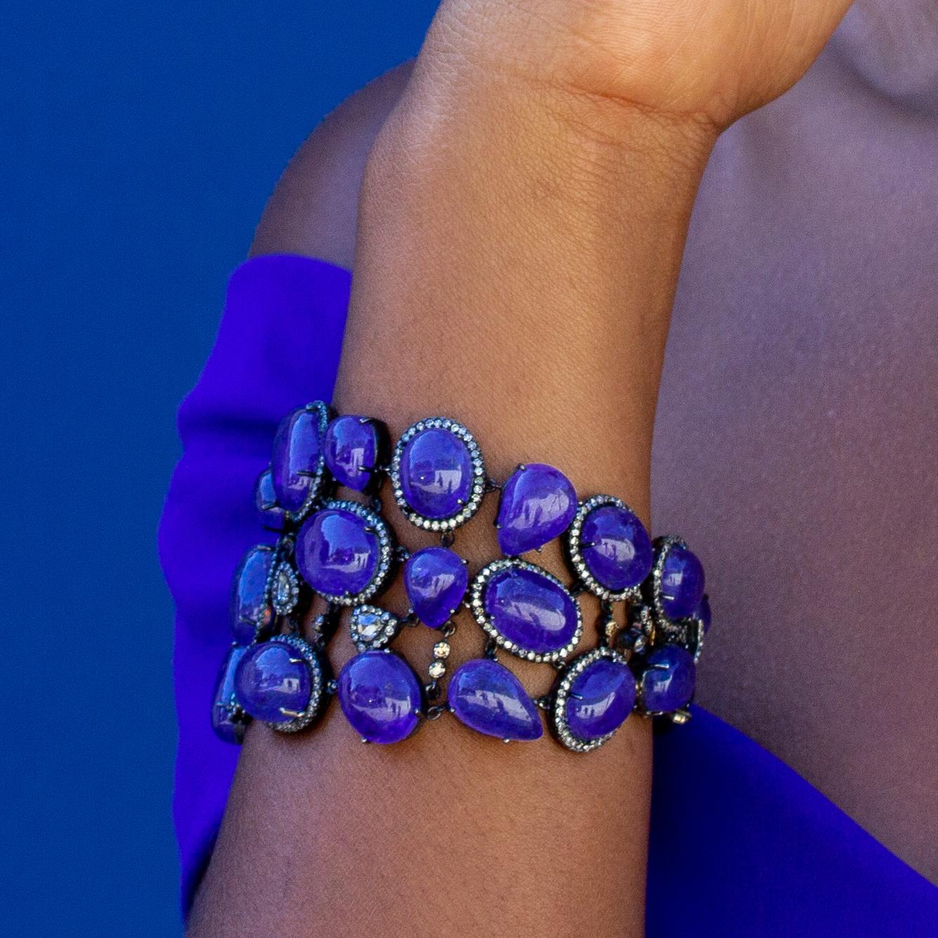 This incredibly flexible bracelet features a suite of large blue tanzanite cabochons, 275 carats of tanzanite accented by unique diamonds. Contact us for resizing options on this piece.