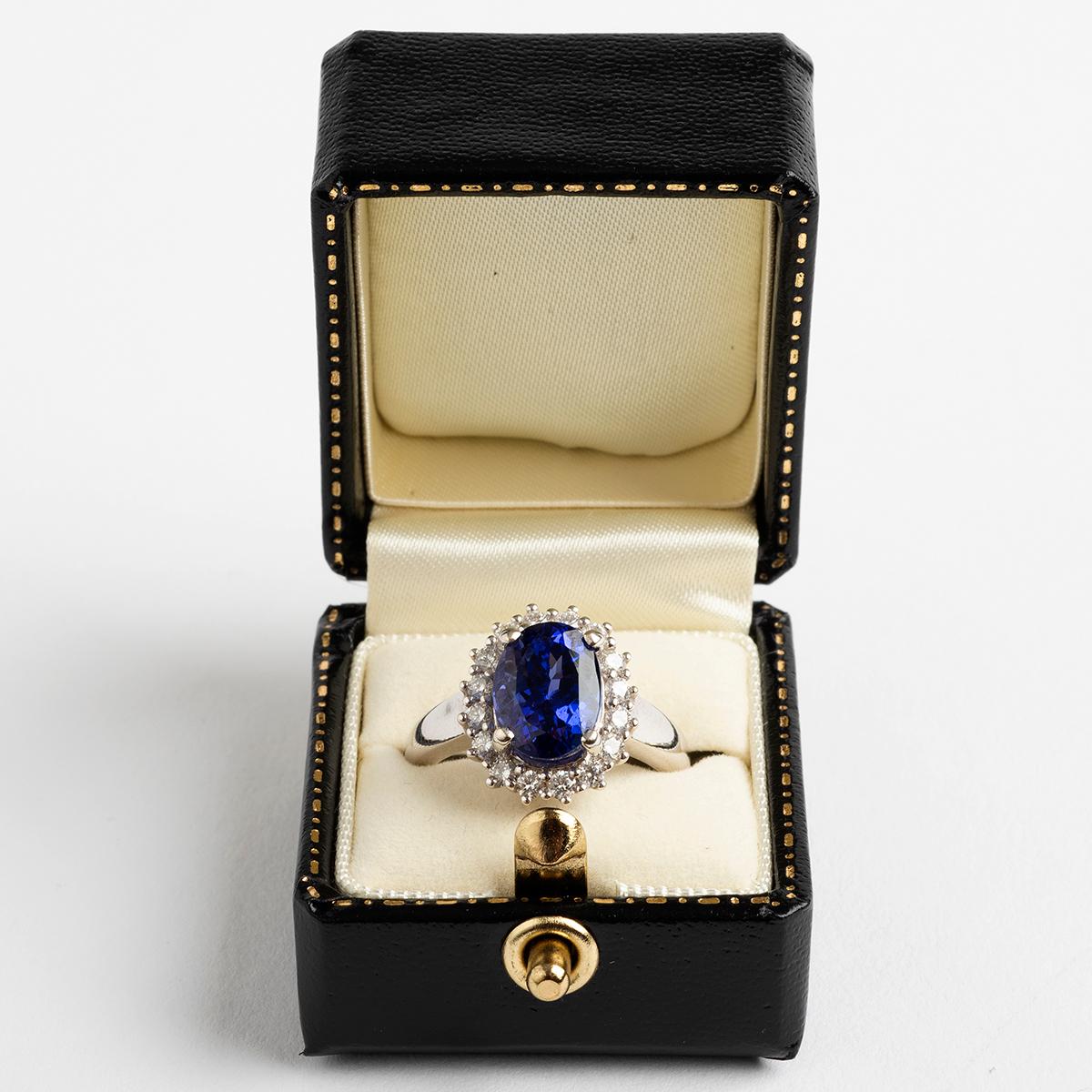 A statement piece, our unusually large and attractive tanzanite (est. 3.76carat) and brilliant cut diamond (est. .5carat) cluster ring evokes an antique style. Set on a 18k white gold band, hallmarked London, 2015. The ring size is M.