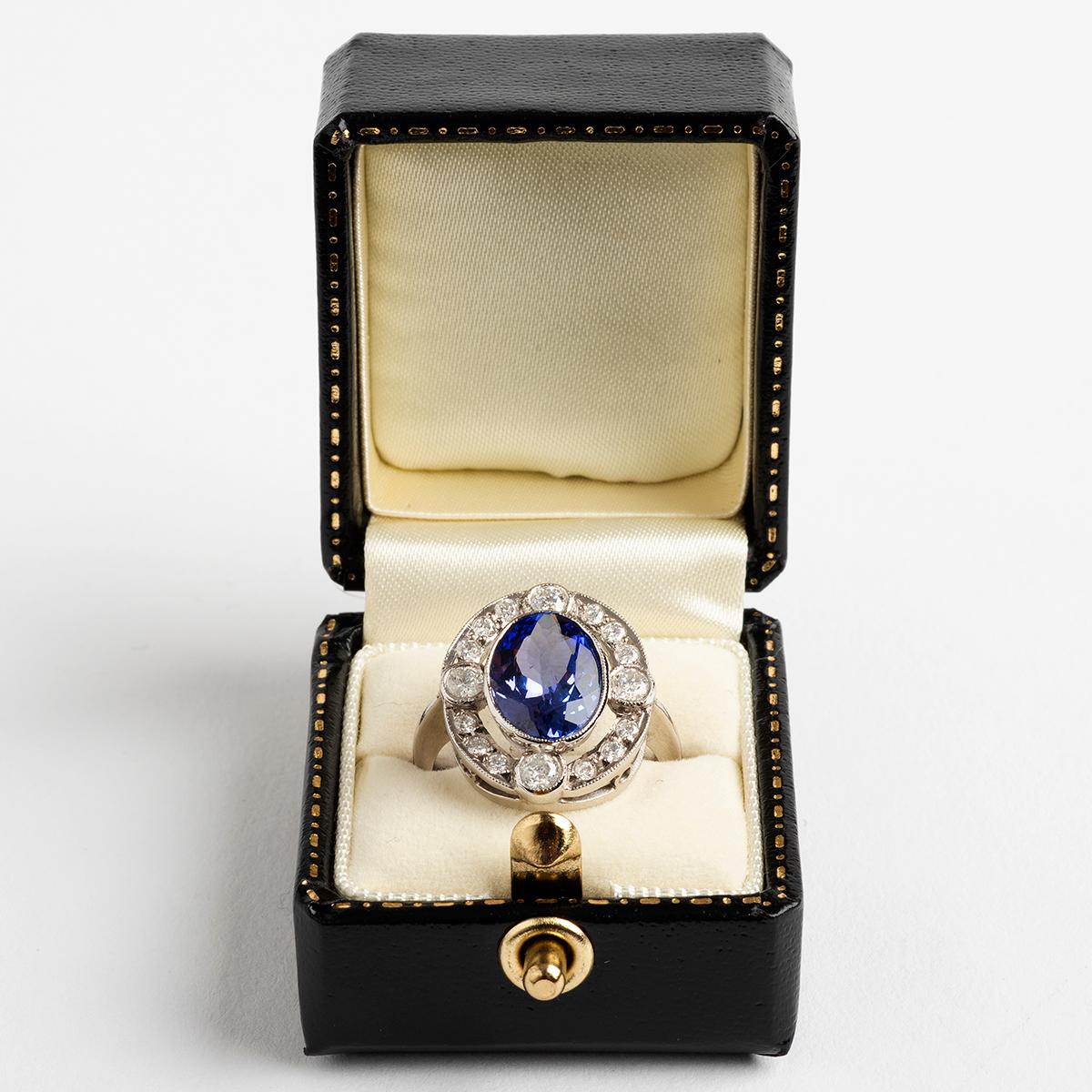 Our extremely large tanzanite (est. 8.5ct) and diamond (est. 1.00ct) cluster ring with 18k white gold band also features a migraine rubber setting. A wonderful statement ring, certain to add to any serious collection. The ring size is N.

A unique