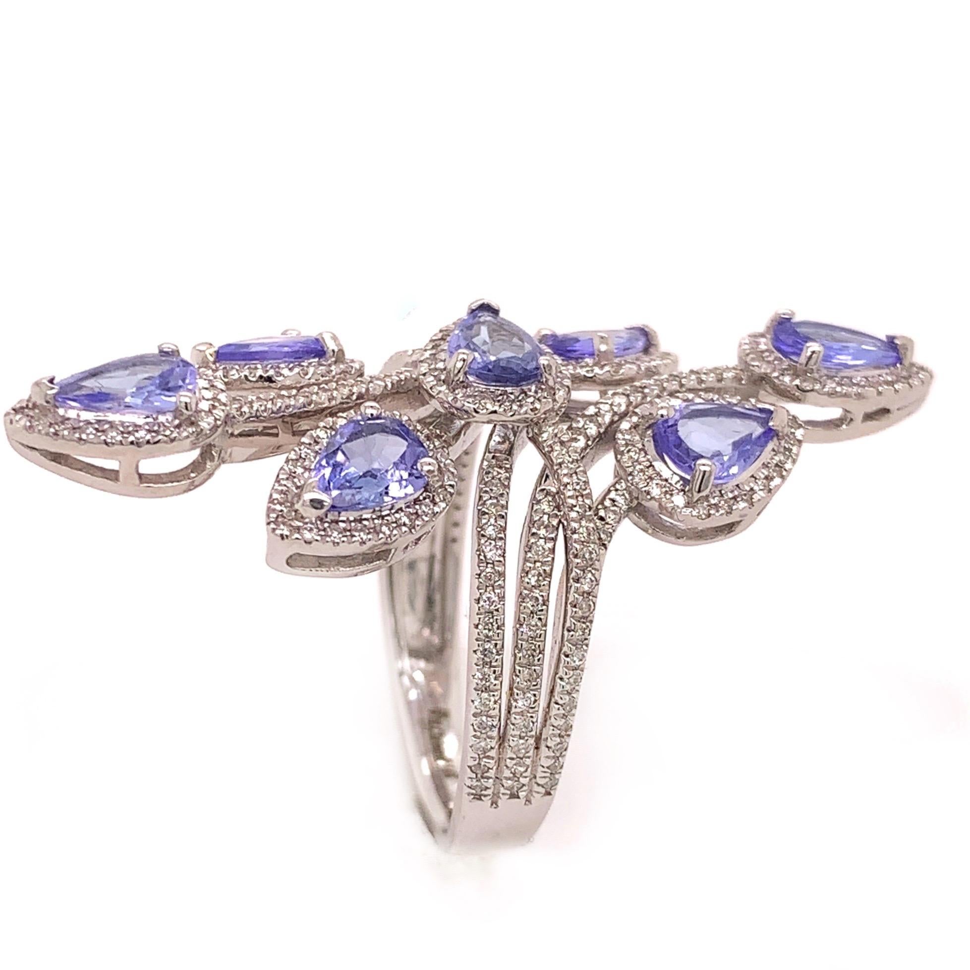 Glamorous tanzanite diamond cocktail ring. High brilliance, lively violet-purple, pear shape faceted natural 1.91 carats tanzanite mounted in open profile with bead prongs accented in round brilliant cut diamonds. Handcrafted cocktail ring set in