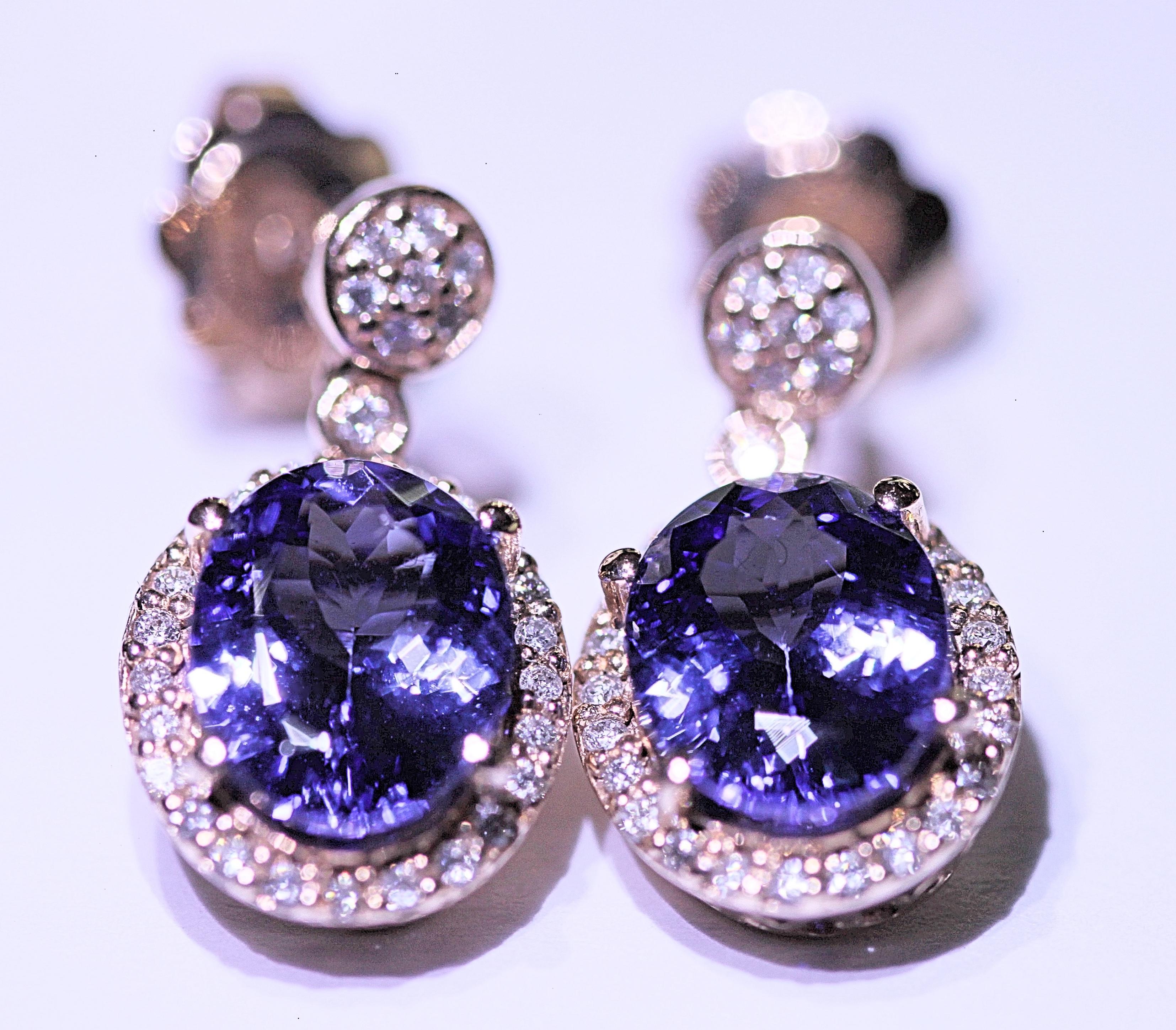 A beautiful pair of tanzanite and diamond earrings.  The earrings consist of two large faceted oval
shaped tanzanites.  The tanzanites weigh 3.40 carats total.  The tanzanites are a rich blue violet
color with lots of sparkle.  The tanzanites are a