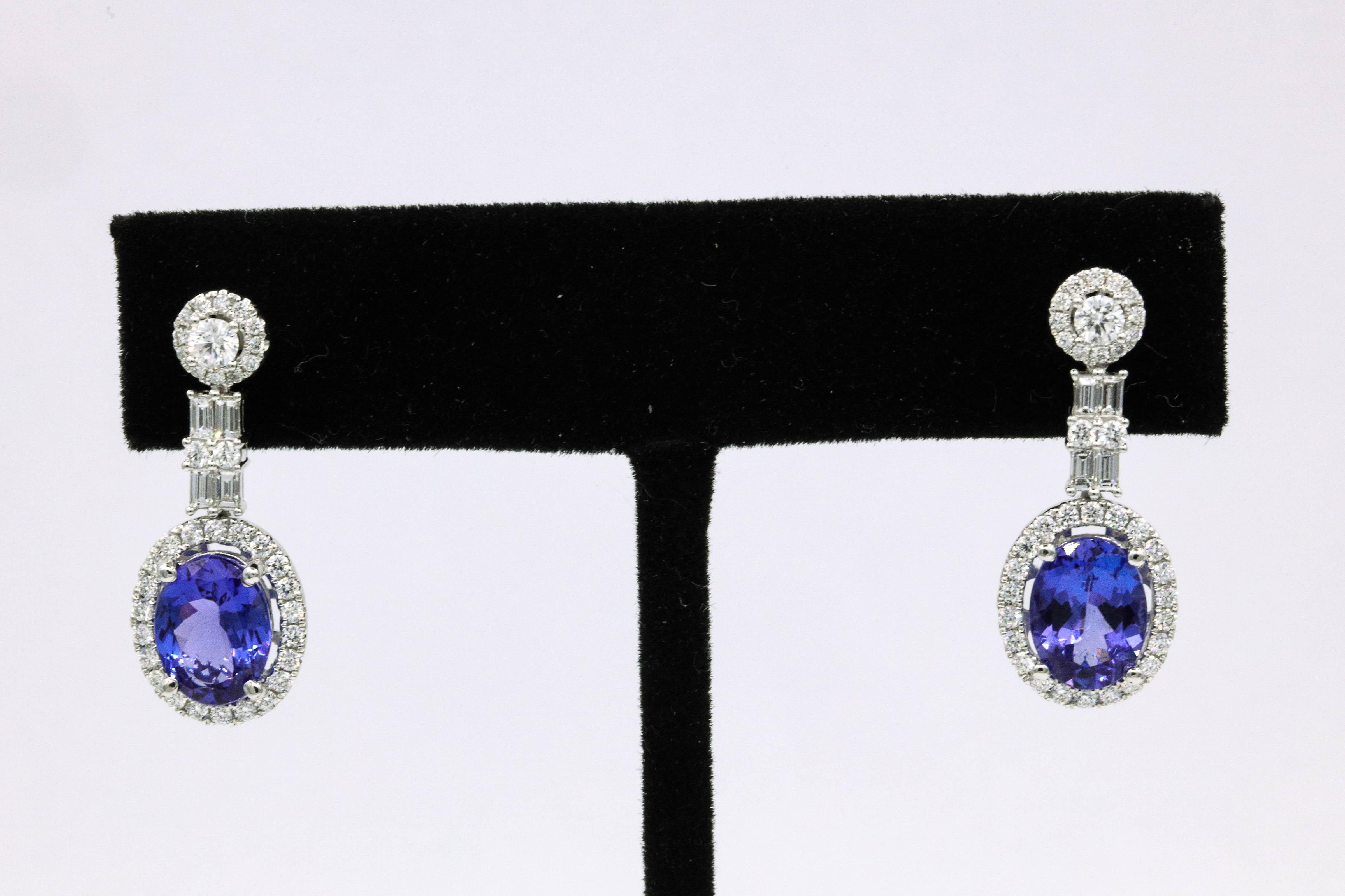 18K White gold drop earrings featuring two oval shape tanzanites weighing 3.30 carats flanked with round and baguette diamonds weighing 1.13 carats.
Color G-H
Clarity SI