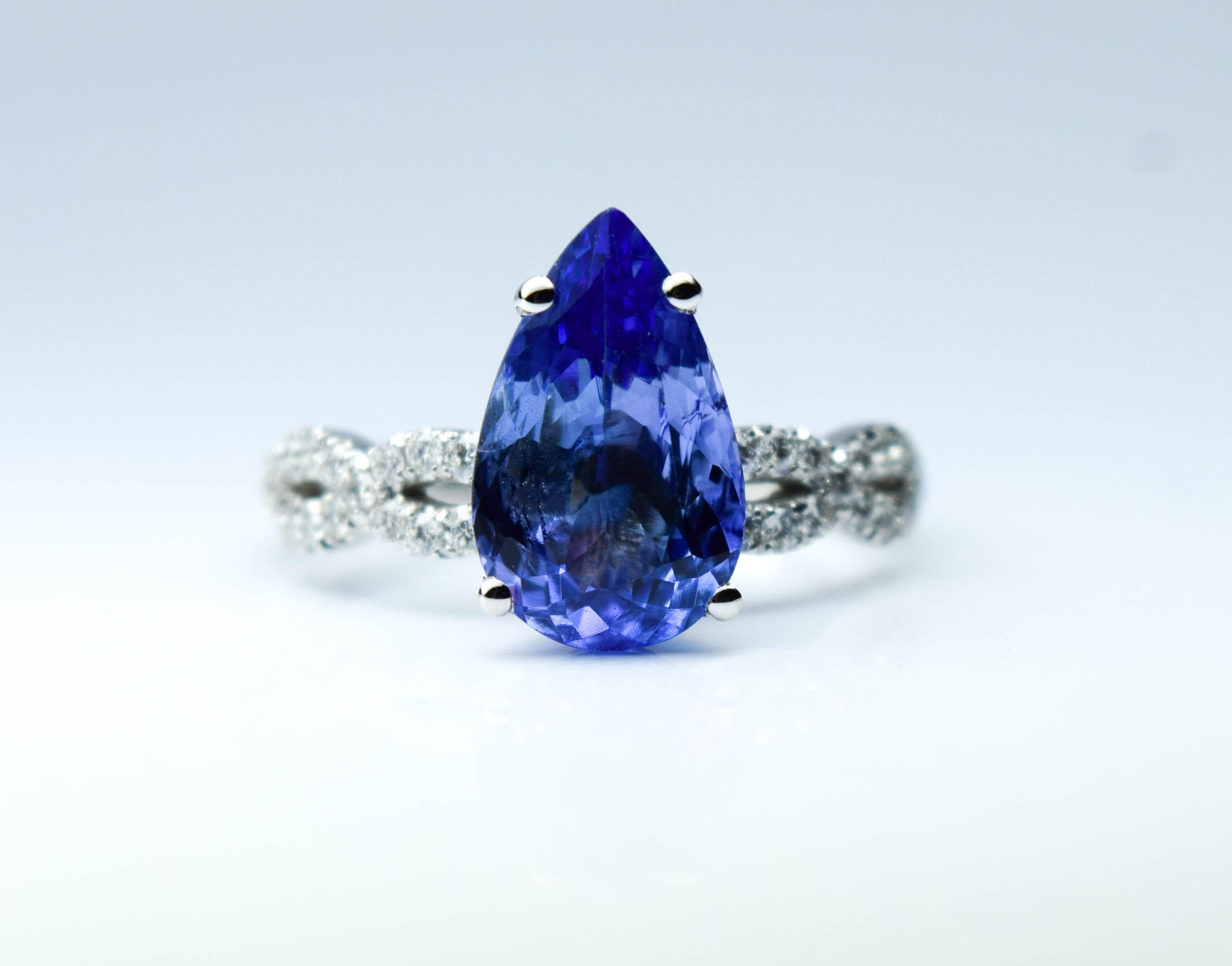 Stunning 1.20 carats center tanzanite with rich violet color accompanied by natural diamonds in a modern design in 18KT white gold. This ring will take 10 days handling time and will come with a box, certificate of authenticity and insured express