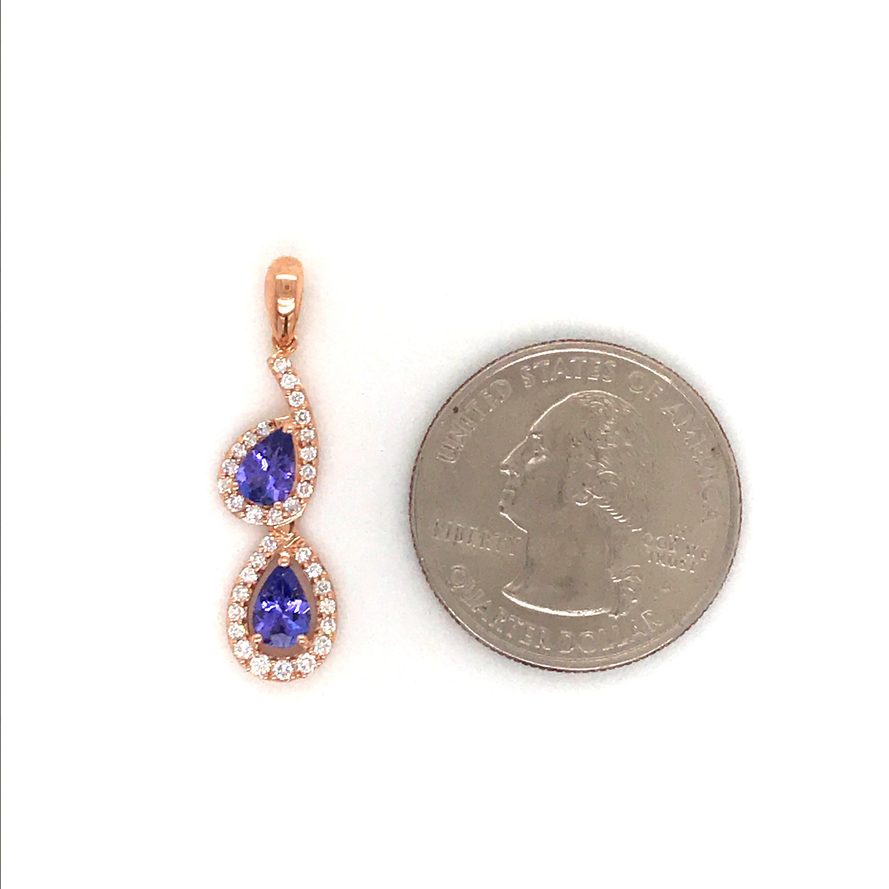 14K Rose gold drop pendant featuring two pear shape tanzanite, 0.82 carats, flanked with round brilliance weighing 0.28 carats. Comes with a 16 inche rose gold chain, 14k. 
Color G
Clarity SI