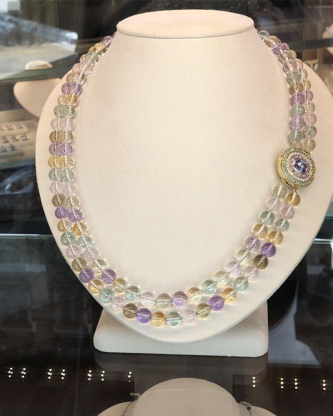 A beautiful necklace made of 921 carats of 10mm natural spodumene beads in a variety of graduated colors. Spodumene is also known more commonly as Kunzite for the pinkish violet variety or Hiddenite for the Green variety. Colors outside of the