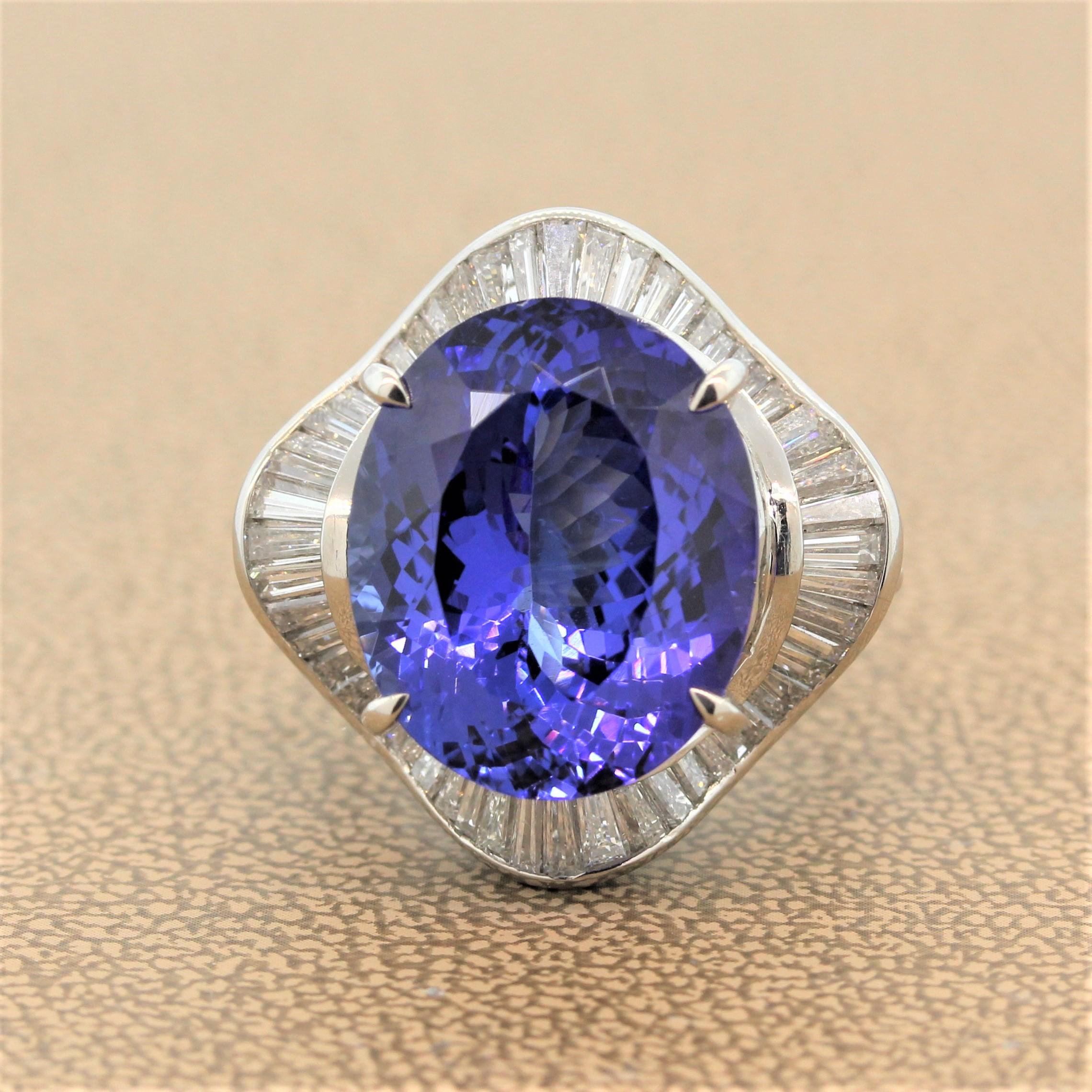 A beautiful platinum ring featuring a 15.33 carat tanzanite with a strong blue color and flashes of purple. The oval cut twinkling tanzanite is haloed by 1.74 carats of baguette cut diamonds in flirty ballerina designed platinum setting.

Ring Size