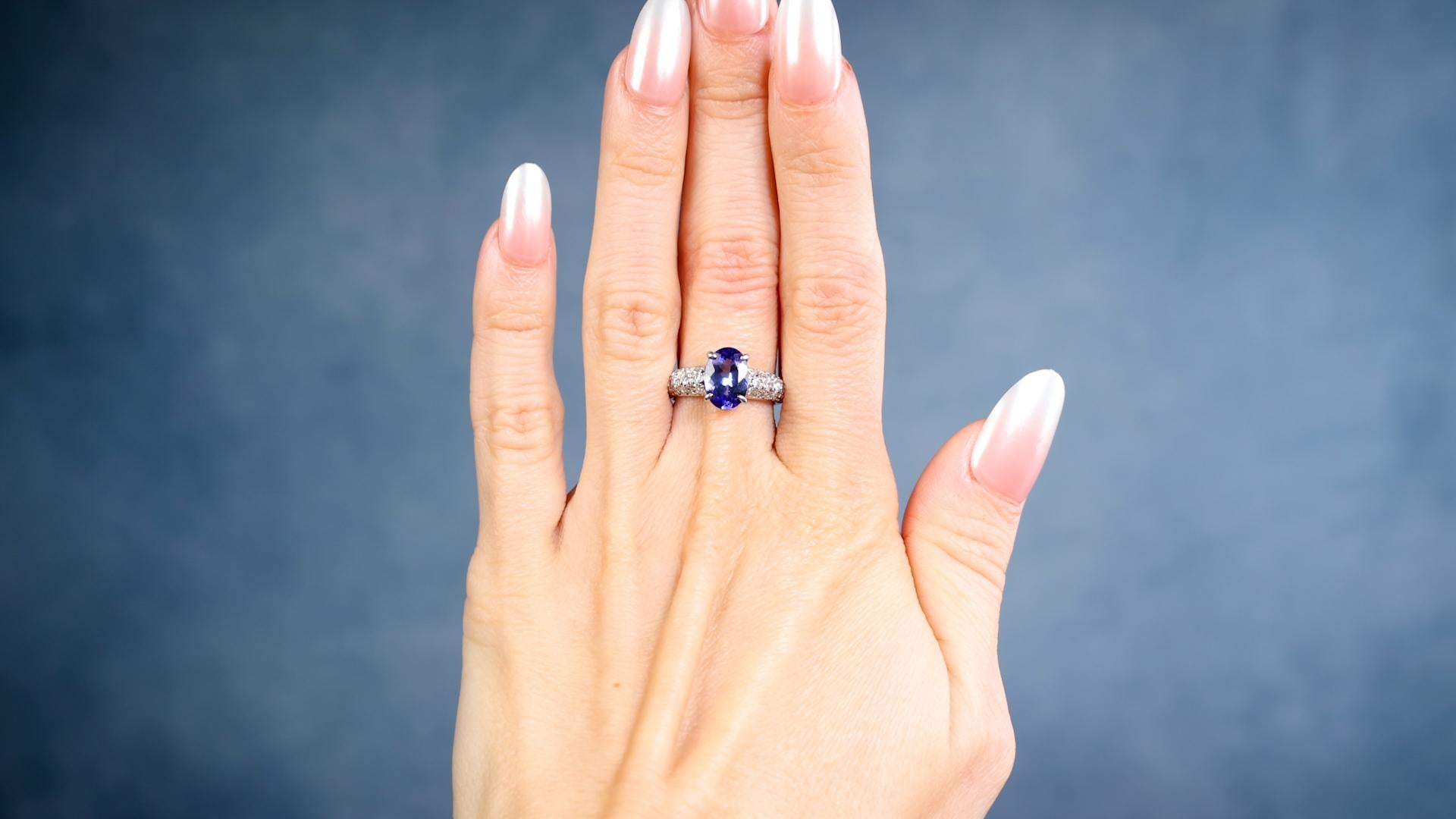 One Tanzanite Diamond Platinum Ring. Featuring one oval cut tanzanite of 1.82 carats. Accented by 30 round brilliant cut diamonds with a total weight of 0.52 carat, graded H-I color, VS clarity. Crafted in platinum with purity mark and gemstone