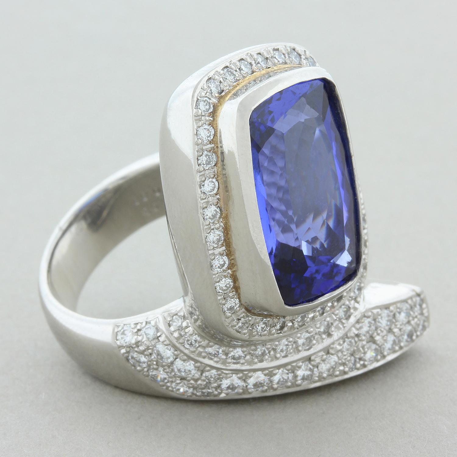 A dazzlingly unique ring featuring an 8.93 carat tanzanite which is haloed and accented by round brilliant cut diamonds totaling 0.88 carats. The bezel set tanzanite is in a platinum setting with its own stand showcasing the radiant cut