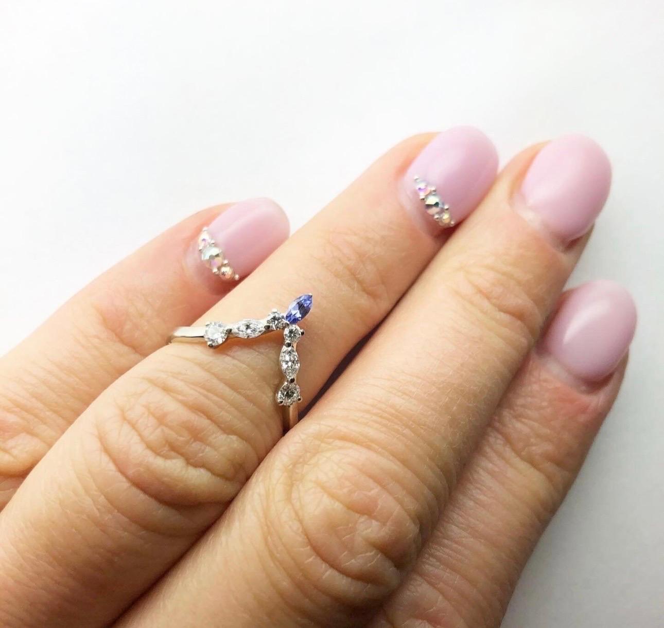 Stunning unusual weddins band made in a V shape for victory with natural diamonds and natural violet tanzanite in 14kt white gold. The ring is so versatile it looks great on its own and with most engagement rings!

Certificate of authenticity comes
