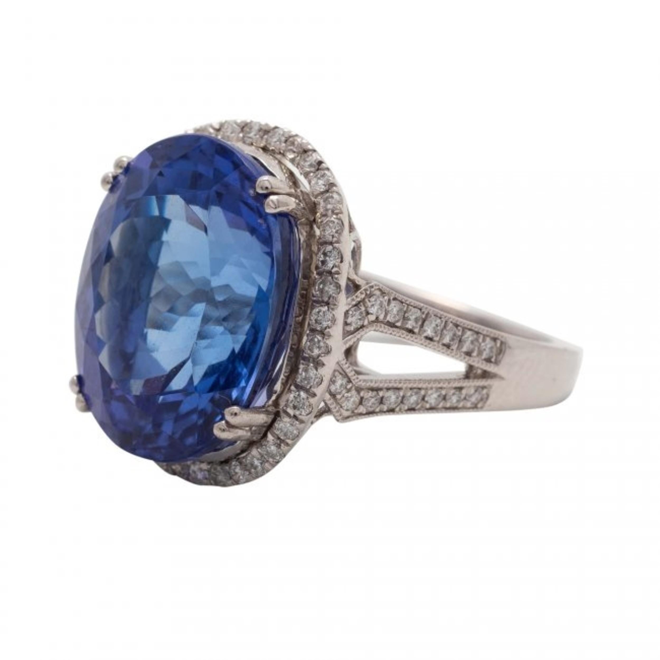 
Tanzanite and Diamond Ring 
centered by a oval faceted tanzanite weighing approximately 11.56 carats, within a pavé-set frame of round diamonds, weighing approximately .48 carats, mounted in 18 kt white gold 
11.55 grams (gross), size 6 1/2