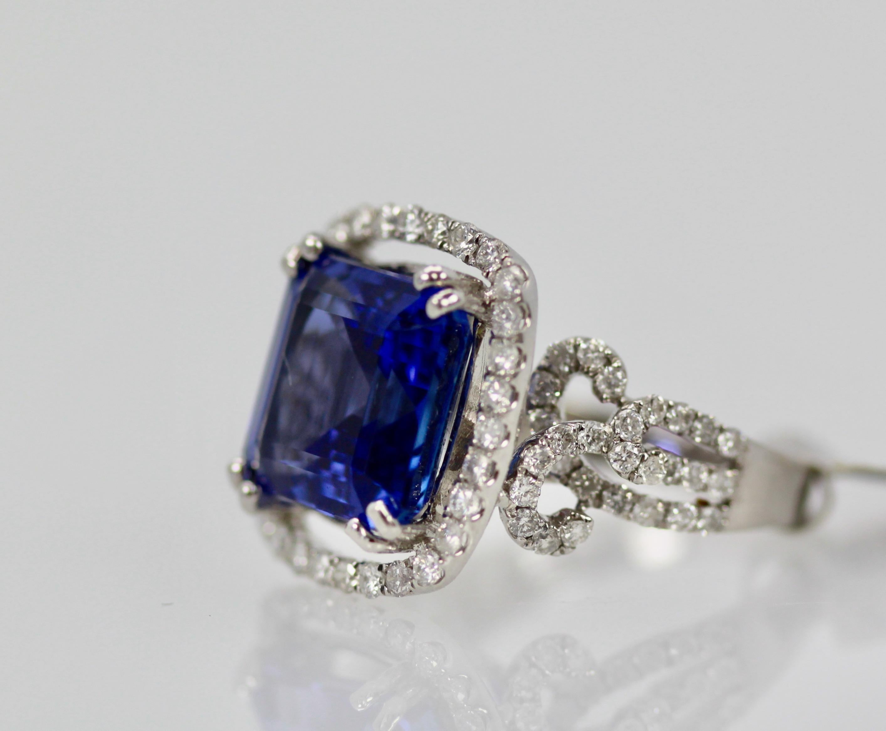This Tanzanite and Diamond ring boosts an exceptional Tanzanite of 8.59 carats.  A beautiful blue exceptionally clean and measures 12.73 x 11.56.  It is in a Diamond surround measuring 15.94 x 17.35.  The Diamonds are white G, VS1 and there are 1.35