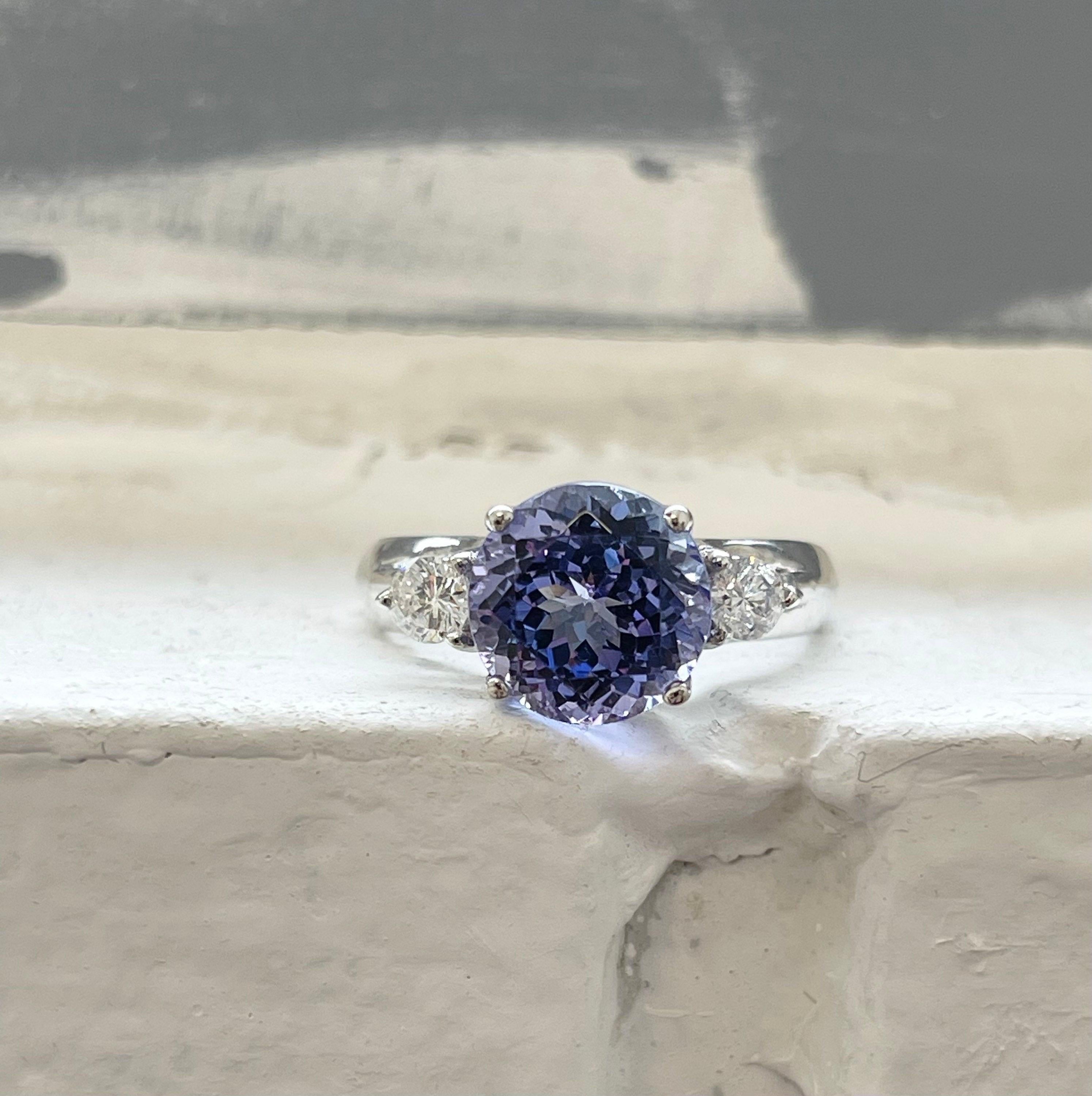 What an incredible Tanzanite & Diamond ring made in 18KT white gold! The center is so gentle not too dark and not too light just the right amount of violet, the diamonds are fine quality VS clarity and F color. The ring is size 6 and can be resized