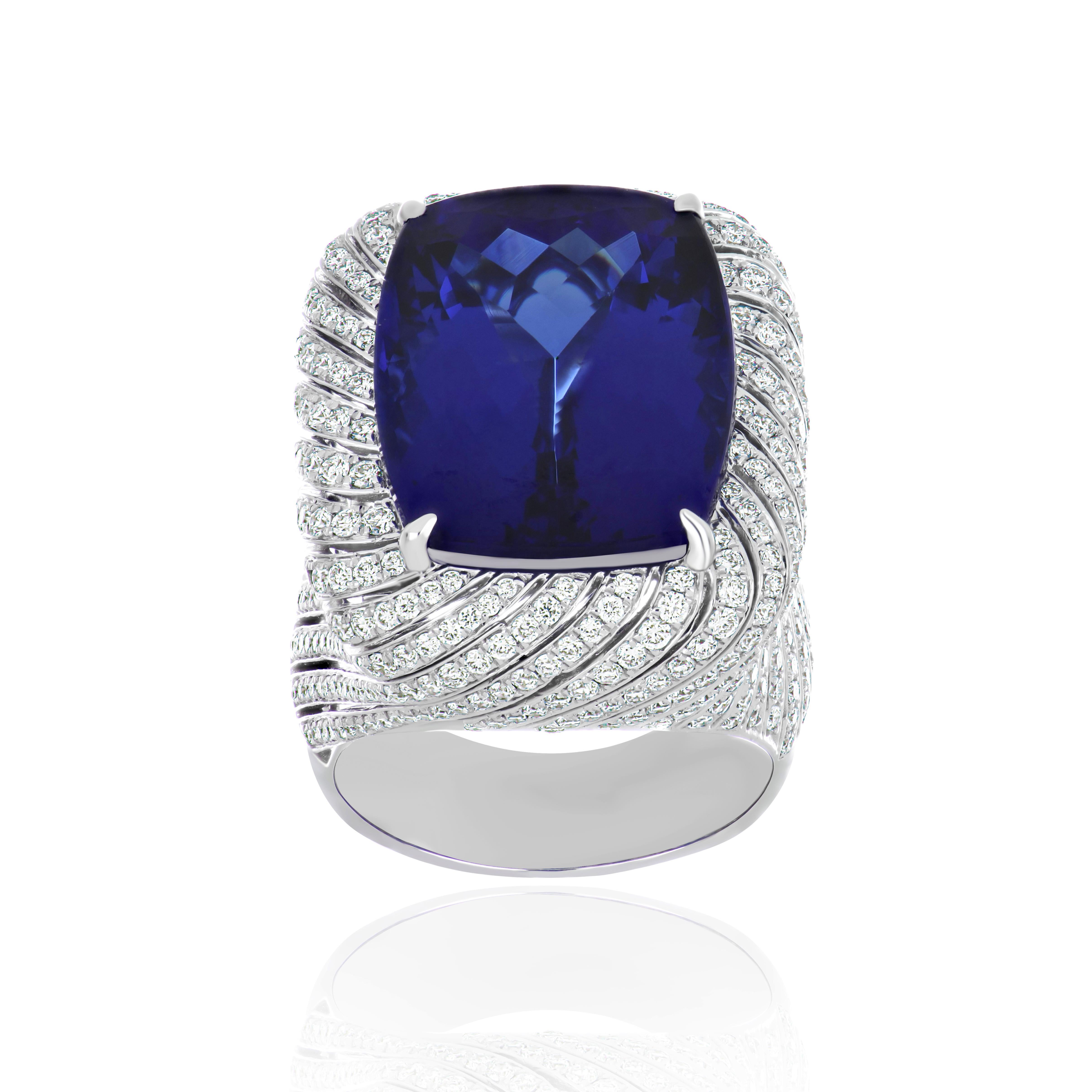 Elegant and Exquisitely detailed White Gold Ring, with a rare 23.8 Cts (approx.) Cushion Shape Cut Tanzanite set in the center beautifully accented with Micro pave set Diamonds, weighing approx. 2.8 CT's (approx). total carat weight to further
