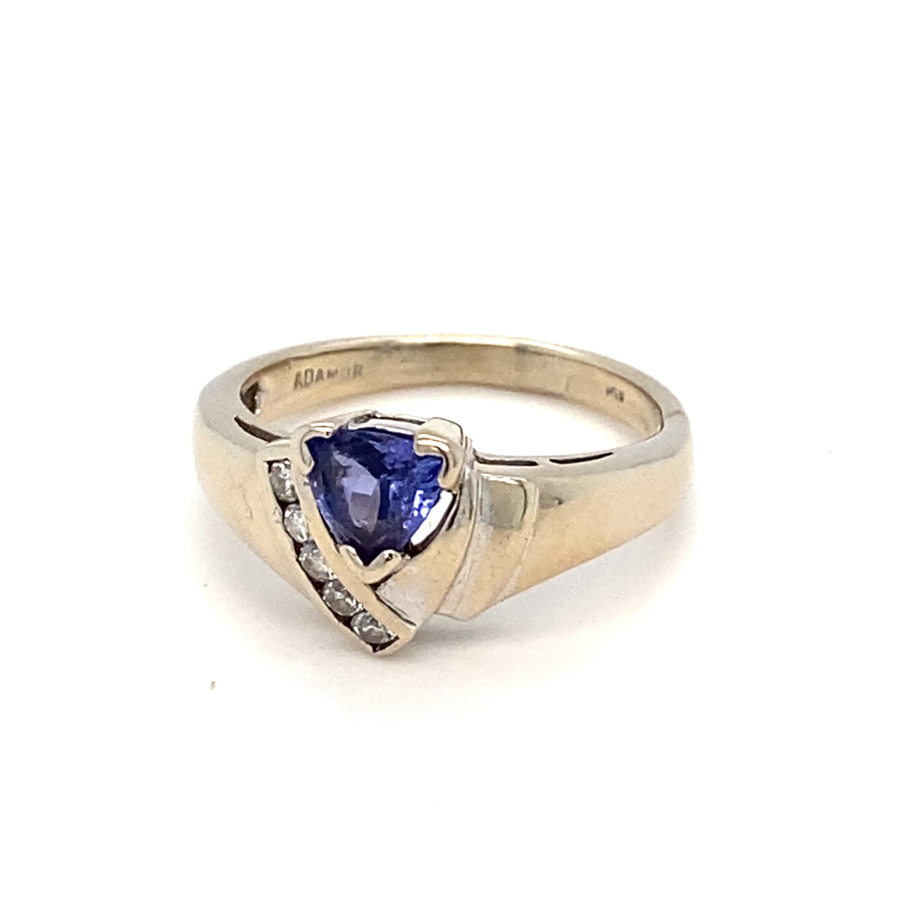 Trillion shape tanzanite with accent diamonds is a everyday wear ring. Set in 14K white gold. Size is resizable 7