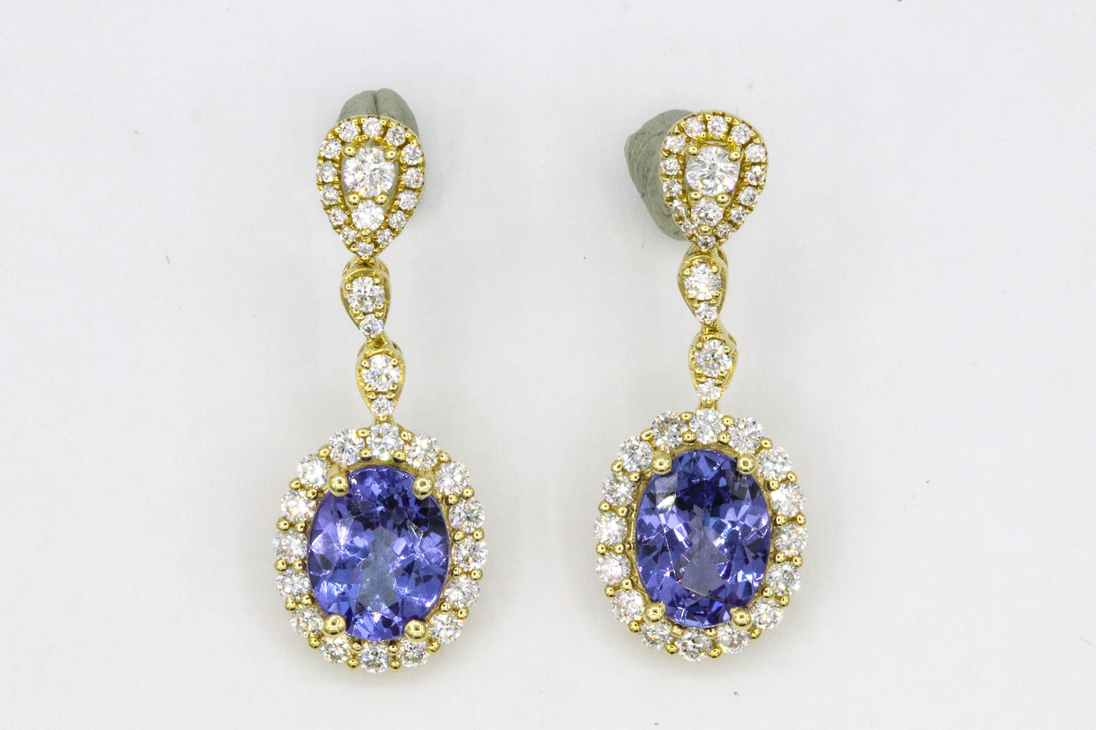 18K Yellow gold earrings featuring two oval shape tanzanites, 3.30 carats, surrounded by round brilliants weighing 1.13 carats.
Color G-H
Clarity SI
Measures 9 x 7 mm