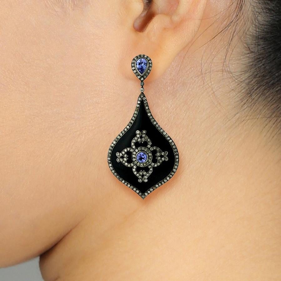 It comes with the Gemological Appraisal by GIA GG/AJP
All Gemstones are Natural
Tanzanite = 2.92 Carats
Diamonds = 2.60 Carats
Black Enamel
Metal: 18K Gold, Silver
Dimensions: 65 x 33 mm