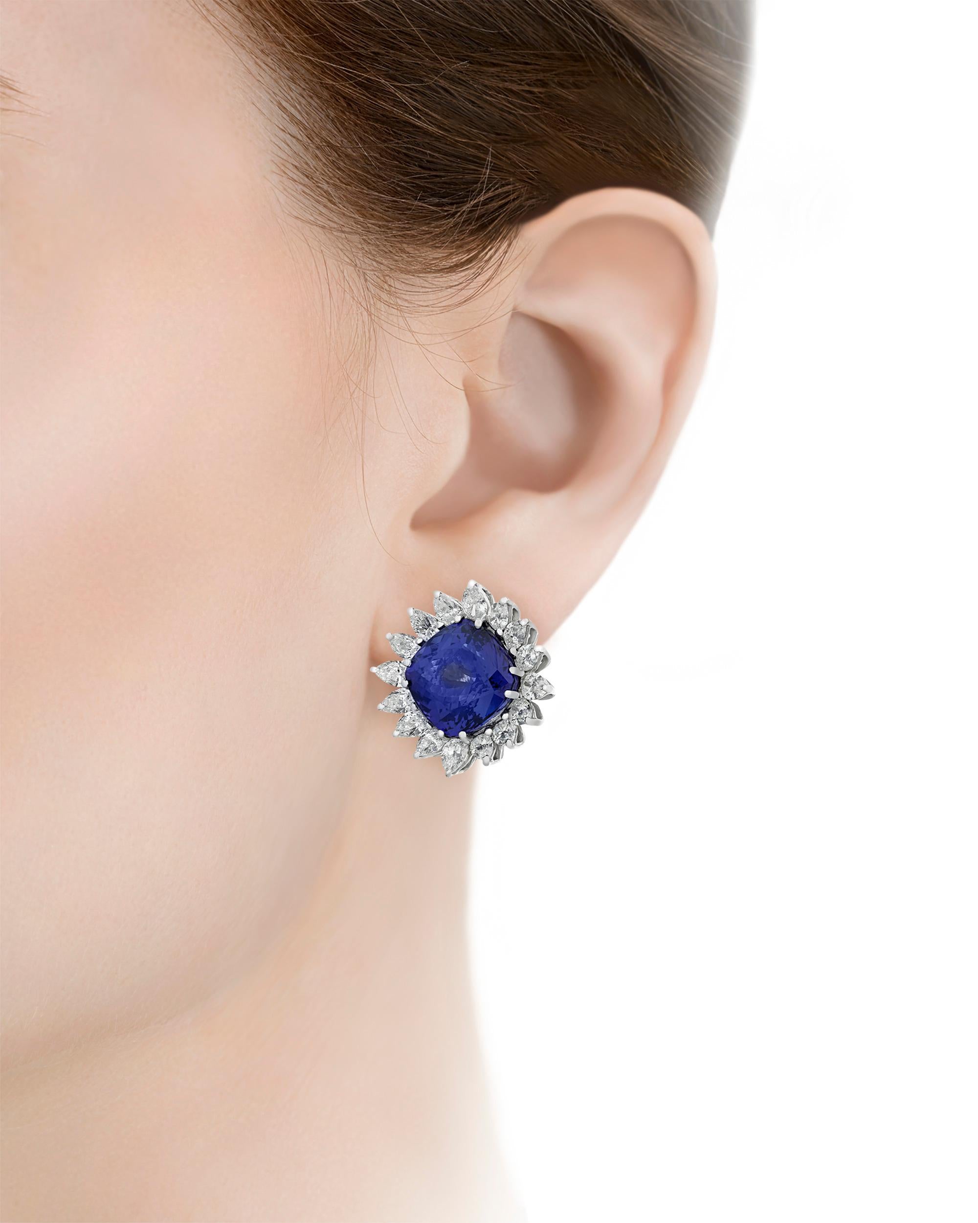 Possessing an entrancing deep blue hue, two extraordinary tanzanites are elegantly displayed within these classic earrings. The cushion-cut jewels are perfectly matched in cut, color, and size, with the pair totaling 17.92 carats. White diamonds