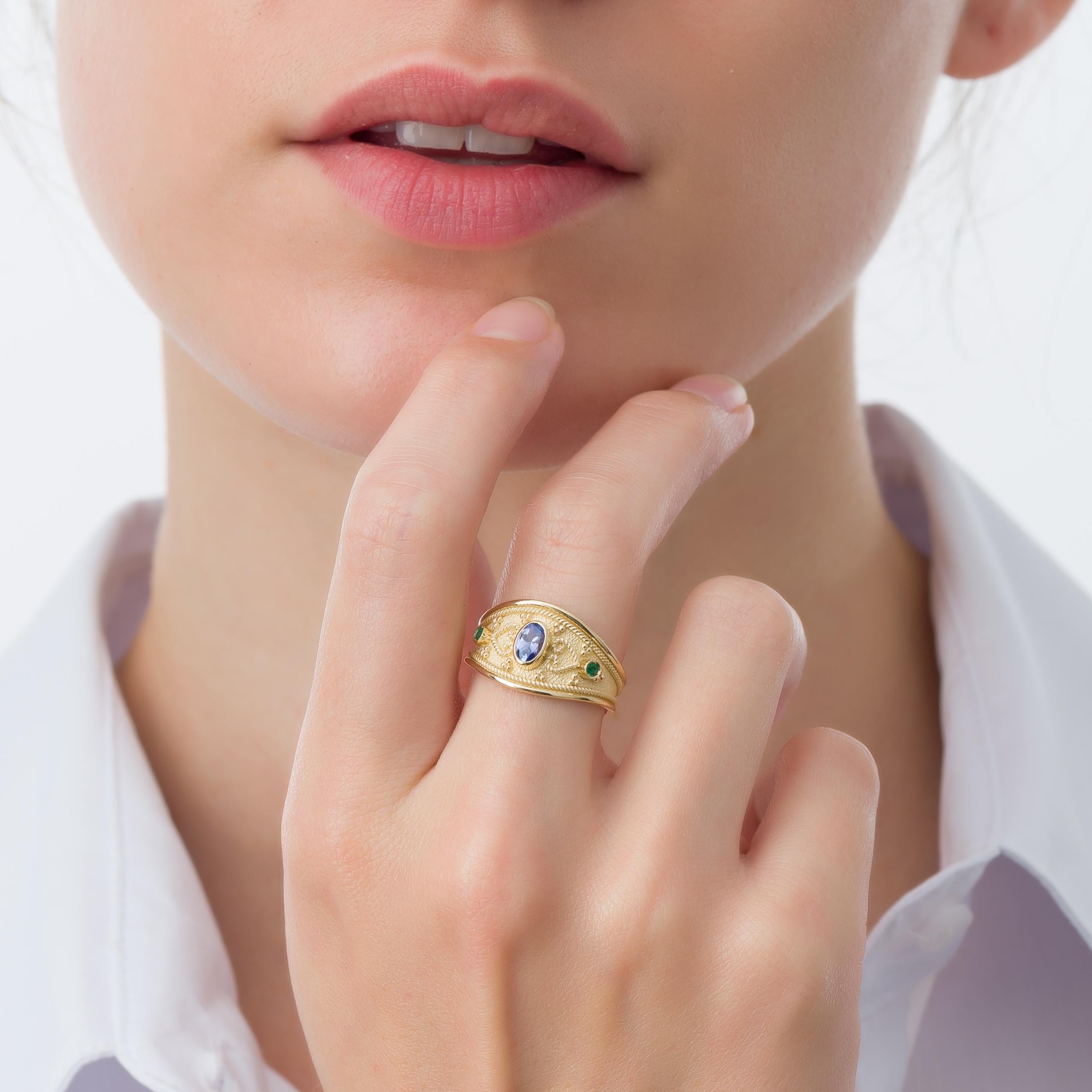 A gold ring featuring an enchanting oval tanzanite, two round emeralds, and intricate Byzantine-era details—an exquisite blend of history and elegance that graces your hand with enduring allure.

100% handmade in our workshop.

Metal: 18K