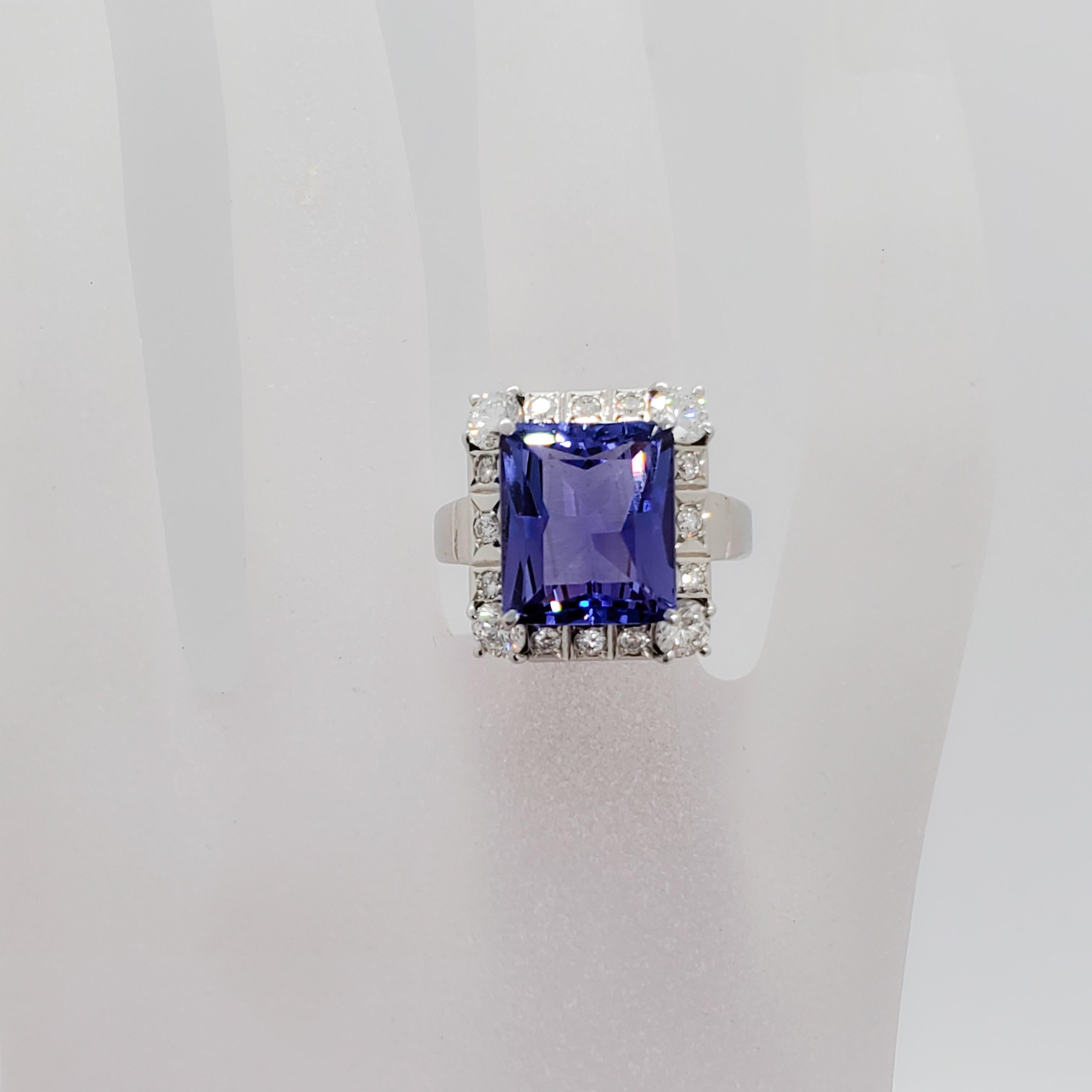 Gorgeous estate deep blue purple tanzanite emerald cut weighing 8.60 ct. with 1.31 ct. of good quality white diamond rounds in a handmade platinum mounting. Ring size 7. Excellent condition.