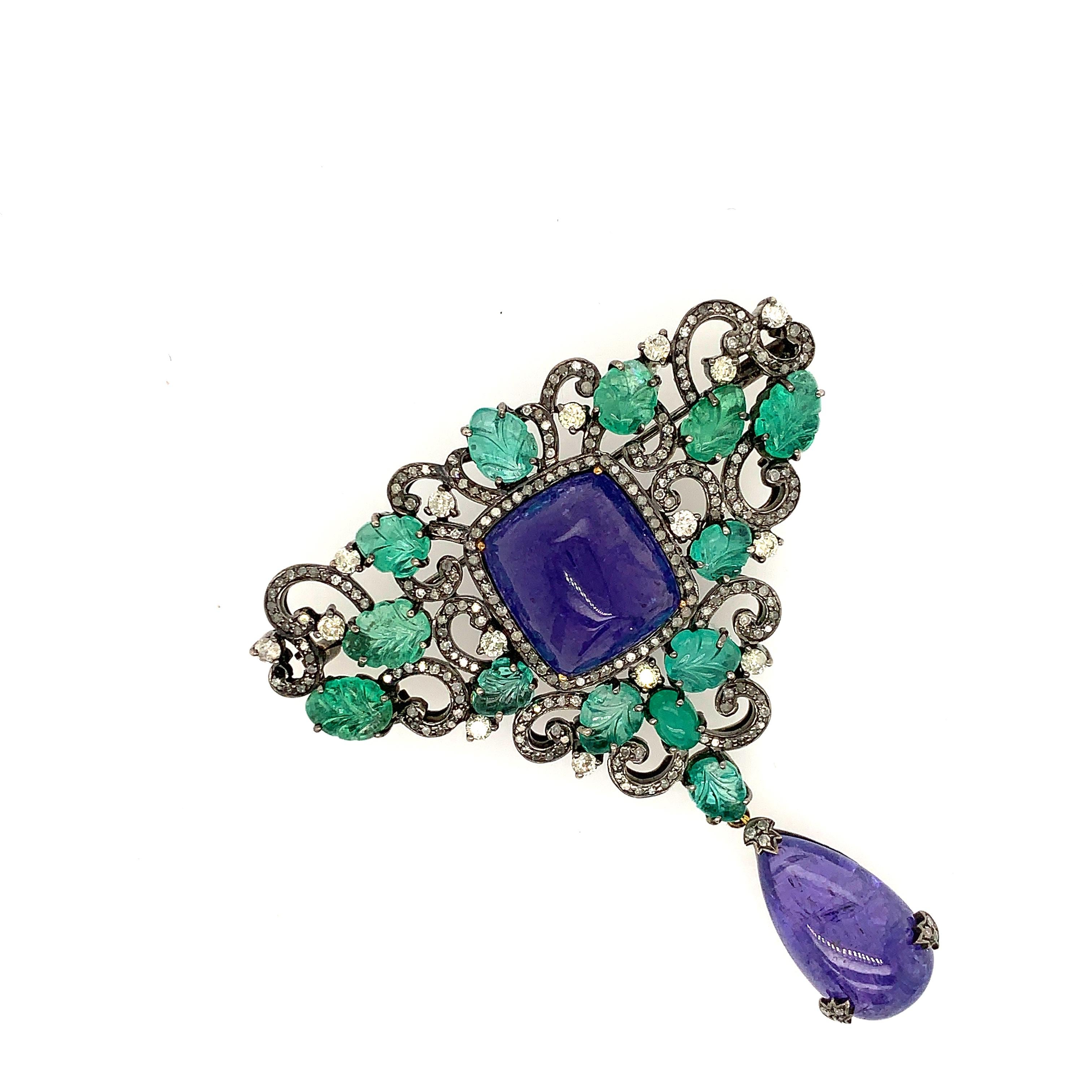 Beautiful Tanzanite Emerald Diamond Designer Brooch which can be converted into pendant also just by slipping a chain through.

18KT: 1.96g
Diamond: 2.04ct
SI: 11.558gms 
EMERALD:11.62ct,
TANZANITE:31.2ct