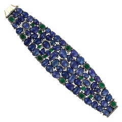 Manchette fantaisie en tanzanite, émeraude et diamants