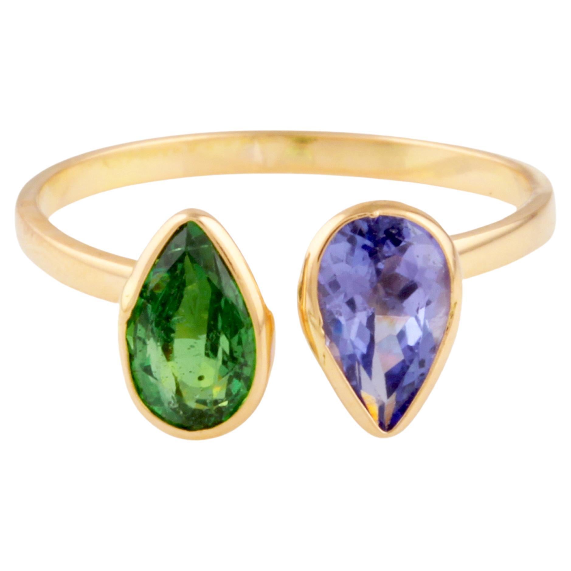 Anillo de tanzanita y esmeralda en forma de pera en oro amarillo de 18 quilates