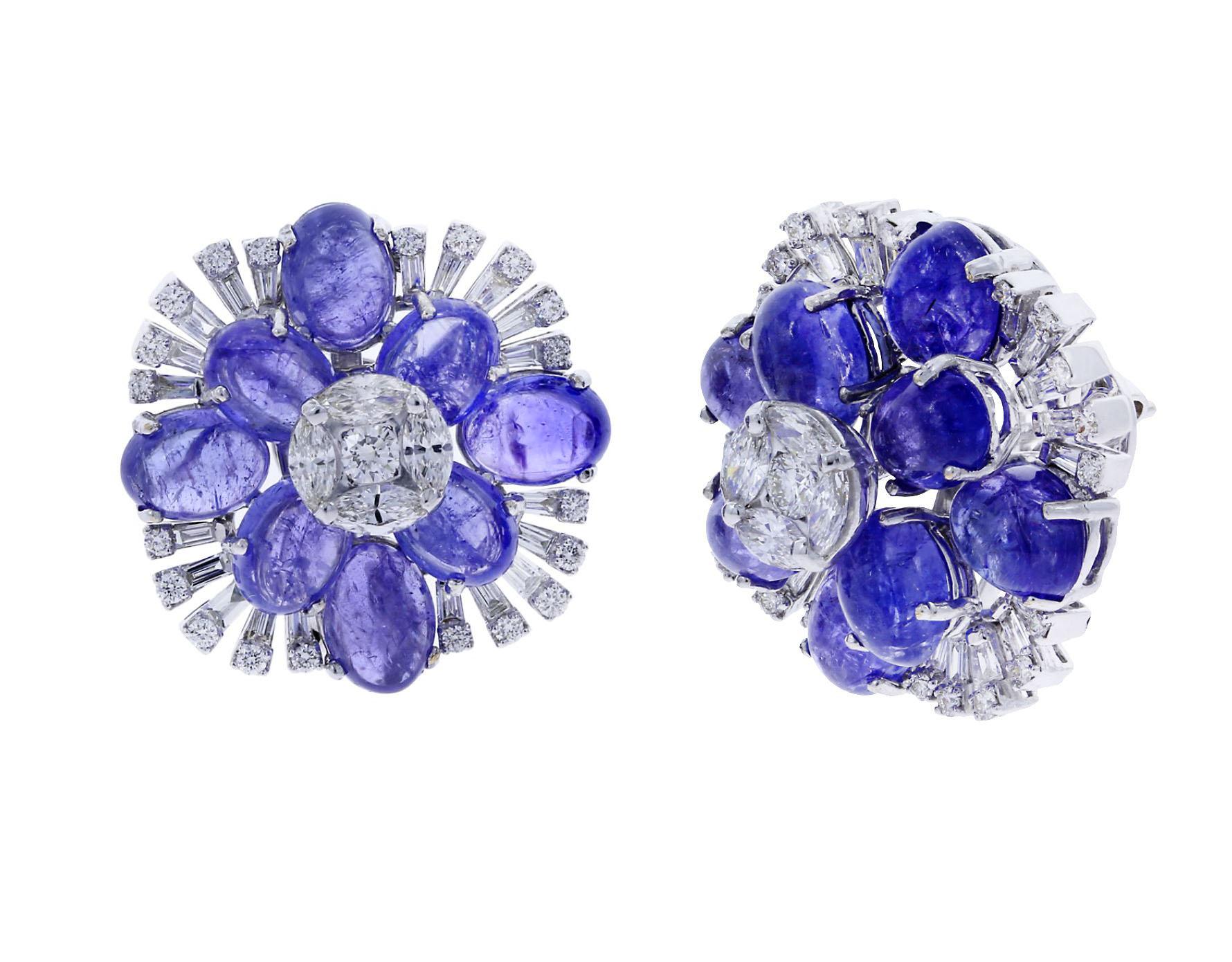 A vibrant pair of Tanzanite Earrings in a floral design with Round Diamonds (0.89 cts), Baguette Diamonds (1.09 cts), Marquise Diamonds (1.14 cts), and Tanzanite (29.9 cts). Measurements 1.18