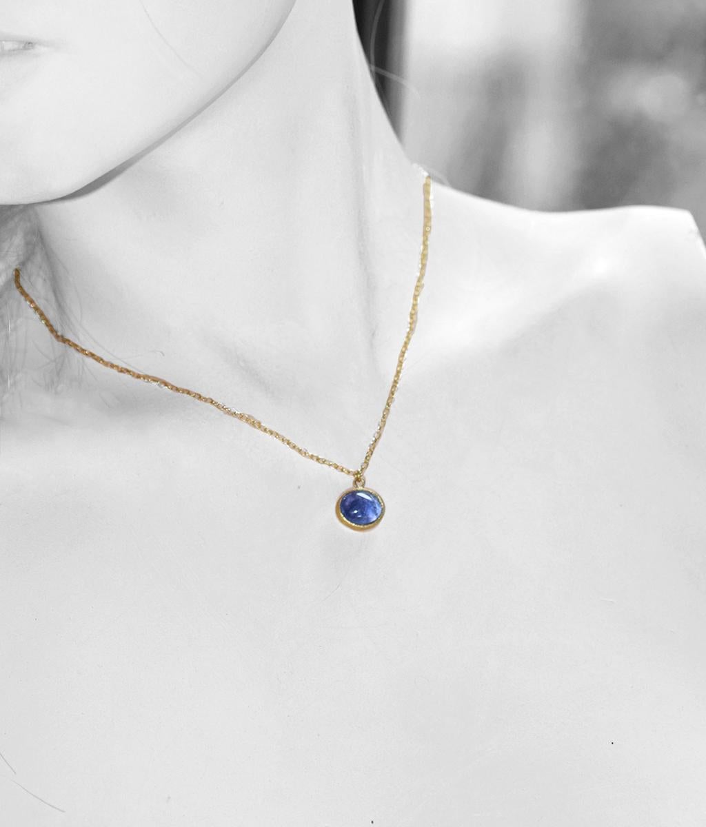 One of a kind Tanzanite cabochon on 18K gold twisted link chain in a simple bezel with texture. Measures: 16