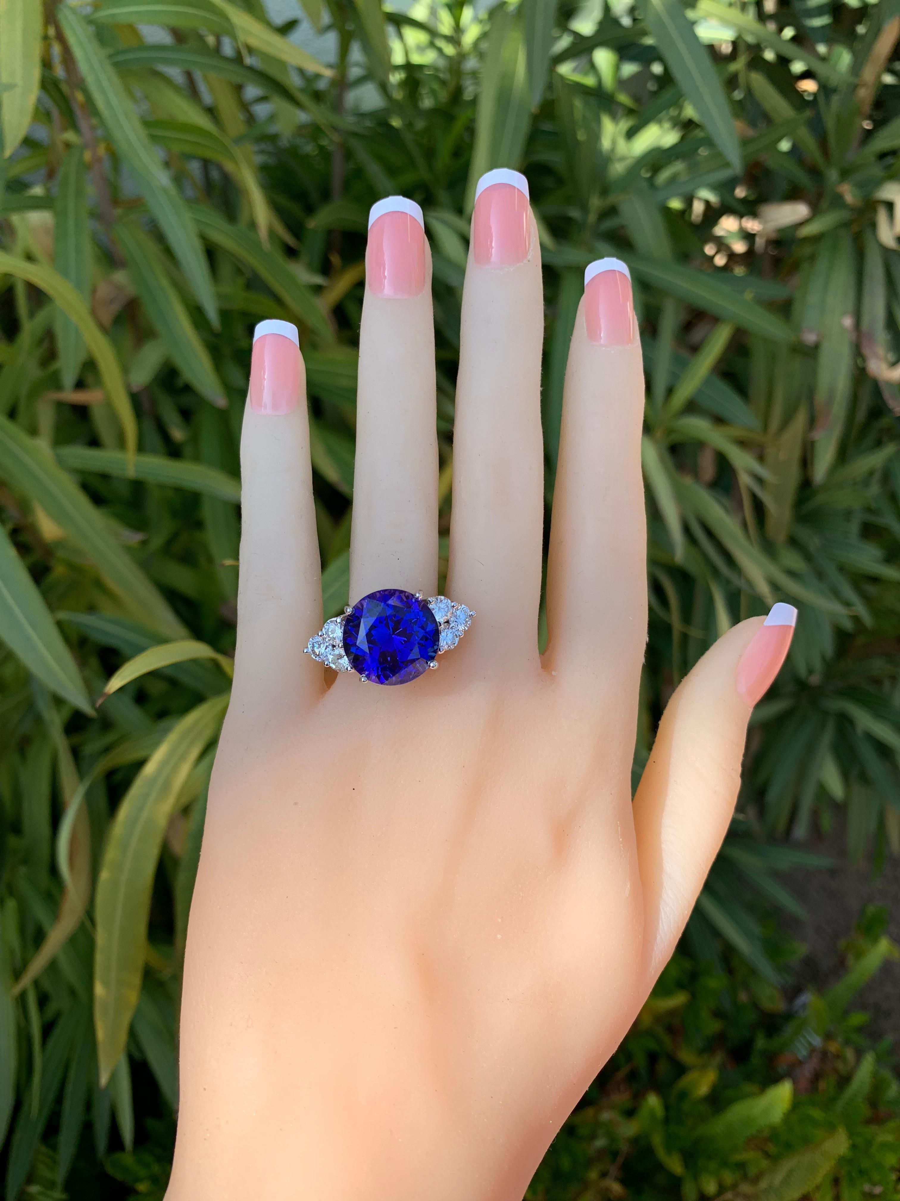 If you would like to see videos of this piece please message me.

Stunning 14.92 ct vivid blue round ideally cut Round Tanzanite with flashes of violet. Set in a hand designed 18k White Gold ring with scroll gallery design. 

The stone is enhanced
