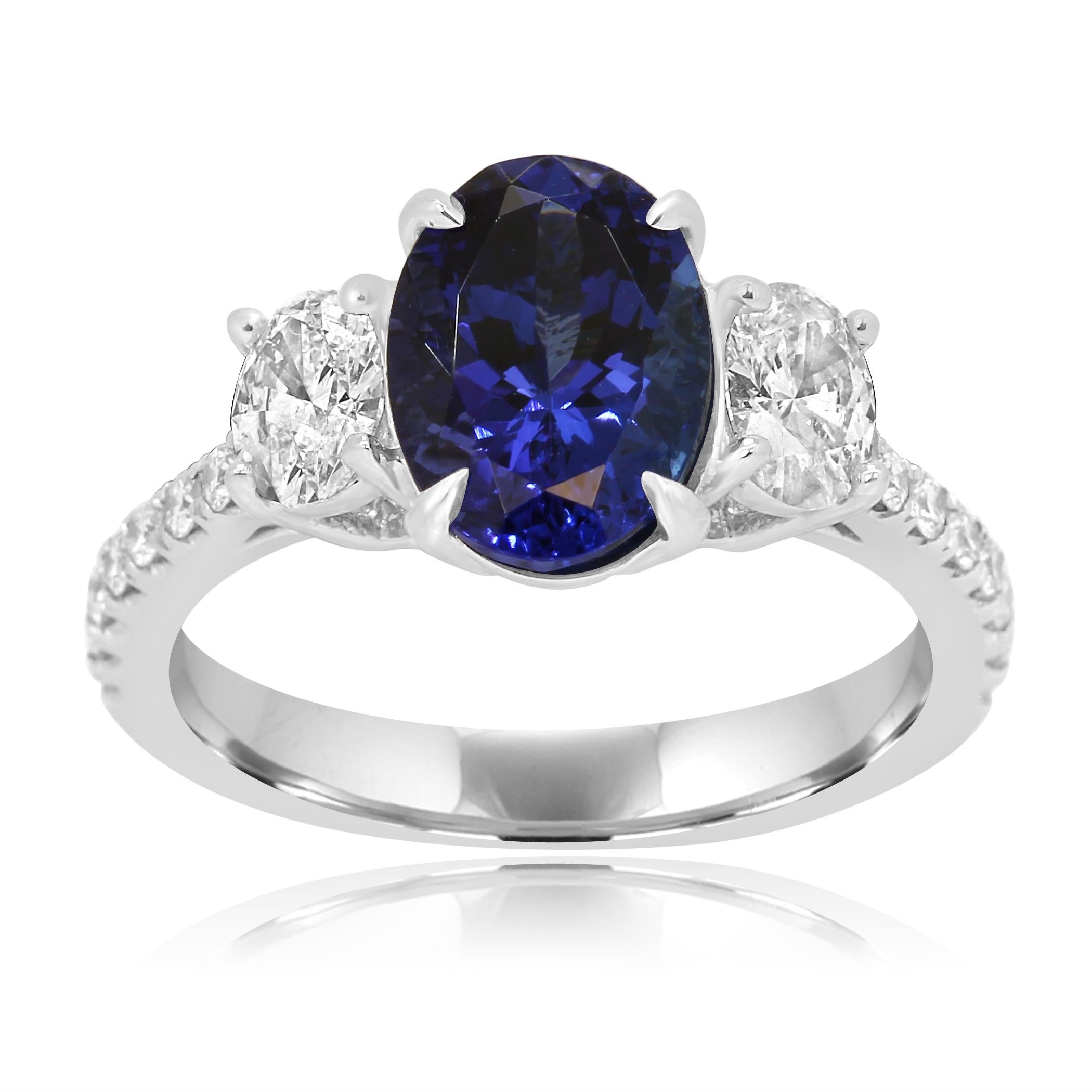 Gorgeous Tanzanite Oval 2.44 Carat Flanked With 2 Colorless Diamond Oval SI Clarity 0.60 Carat and Colorless Diamond Round SI Clarity 0.21 Carat in Classic yet Chic Three Stone Bridal Cocktail 18K White Gold Ring.

Style available in different price