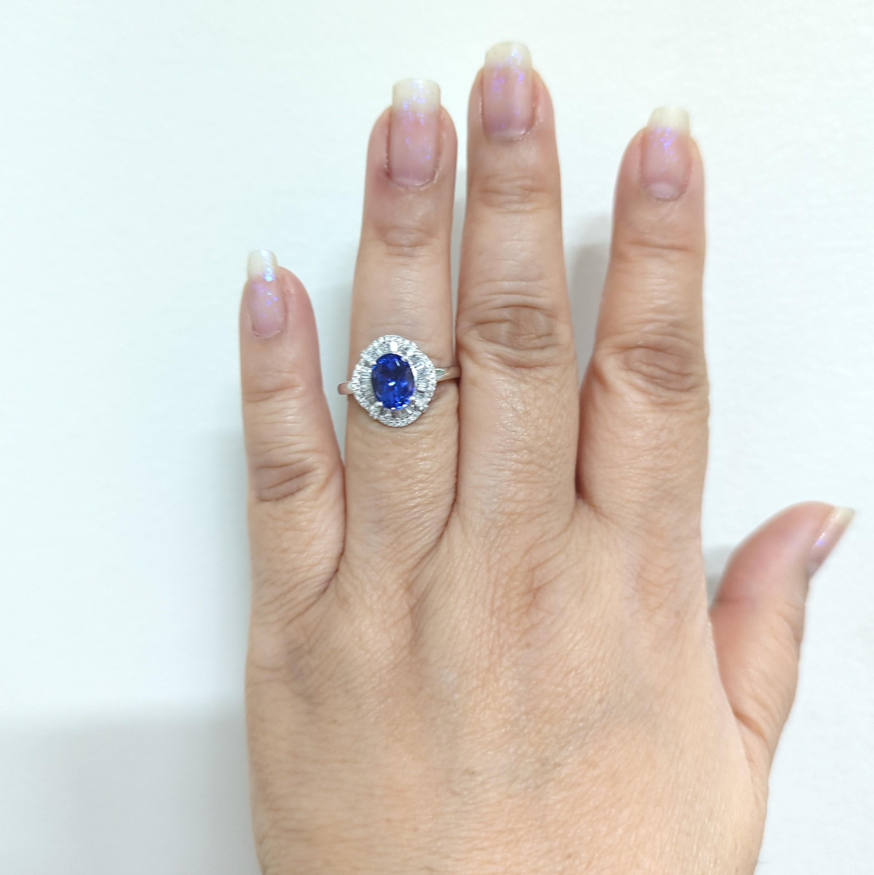 Gorgeous tanzanite oval that weighs 2.15 cts.  The stone looks bigger than the weight and has a beautiful blue purple hue.  The diamonds are white and good quality.  The design is unique and detailed.  Handmade ring in 14k white gold and size 9. 