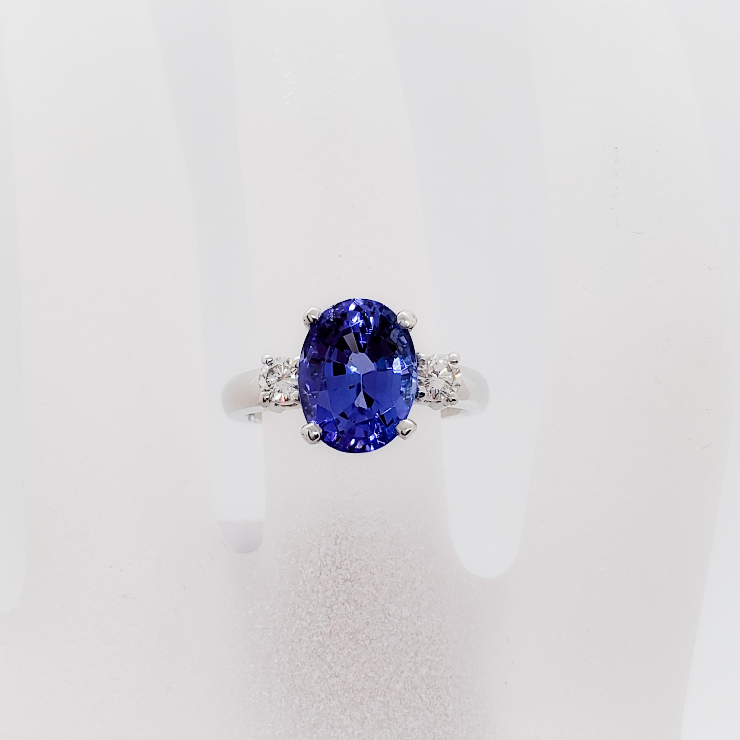 Stunning deep blue purple tanzanite oval weighing 3.49 ct. with 0.25 ct. white diamond rounds that are good quality, white, and clean.  Handmade platinum mounting.  Ring size 6.  Estate piece in mint condition.