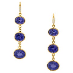 Boucle d'oreille en or jaune 18k avec ovale de tanzanite et diamant
