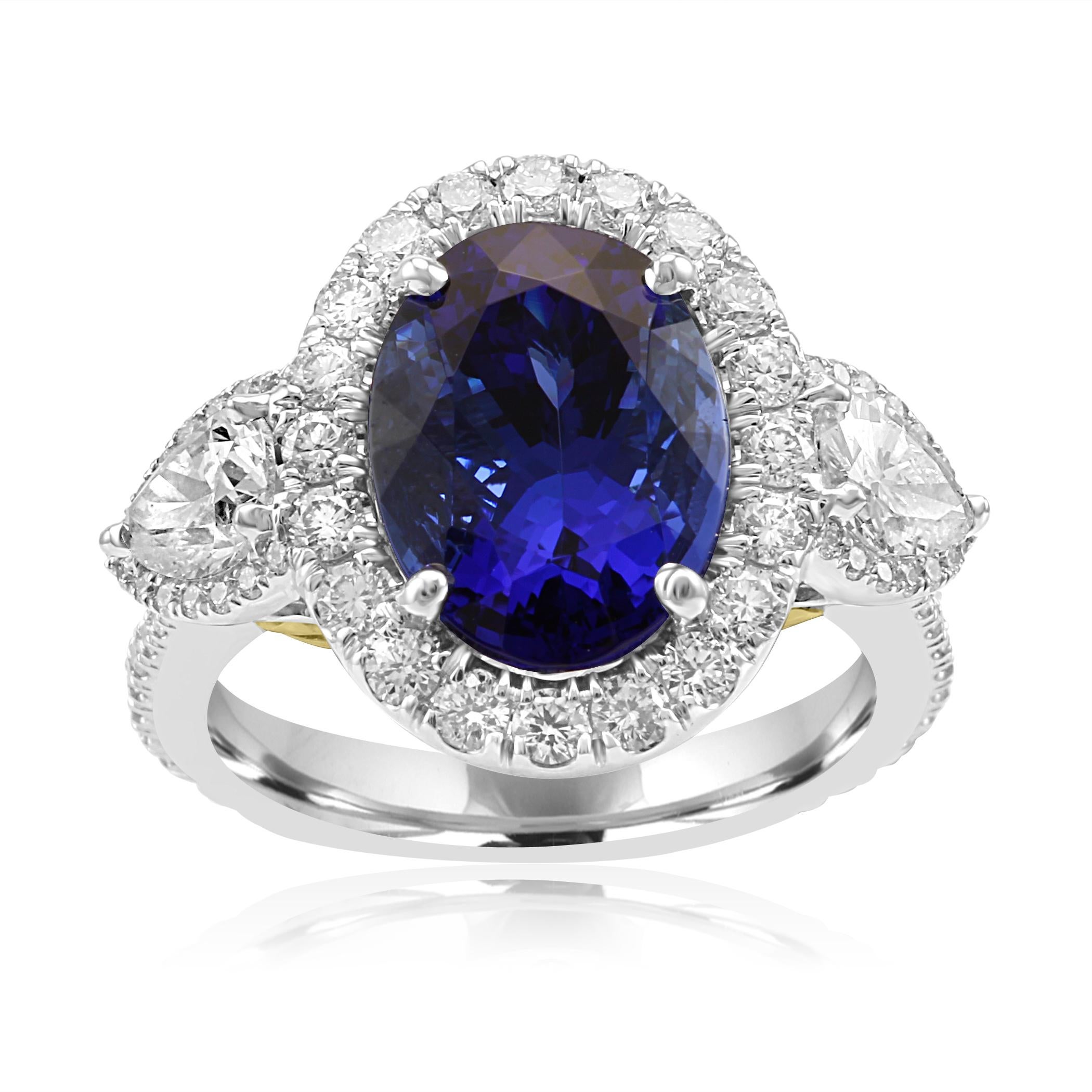 Stunning Tanzanite Oval 4.96 Carat Flanked by 2 White G-H color VS-SI Clarity Diamond Pears 0.75  Carat encircled in single Halo of White G--H Color VS-SI clarity Diamond Rounds 1.00 Carat set in Gorgeous 18K Rose Gold Three Stone Fashion Cocktail